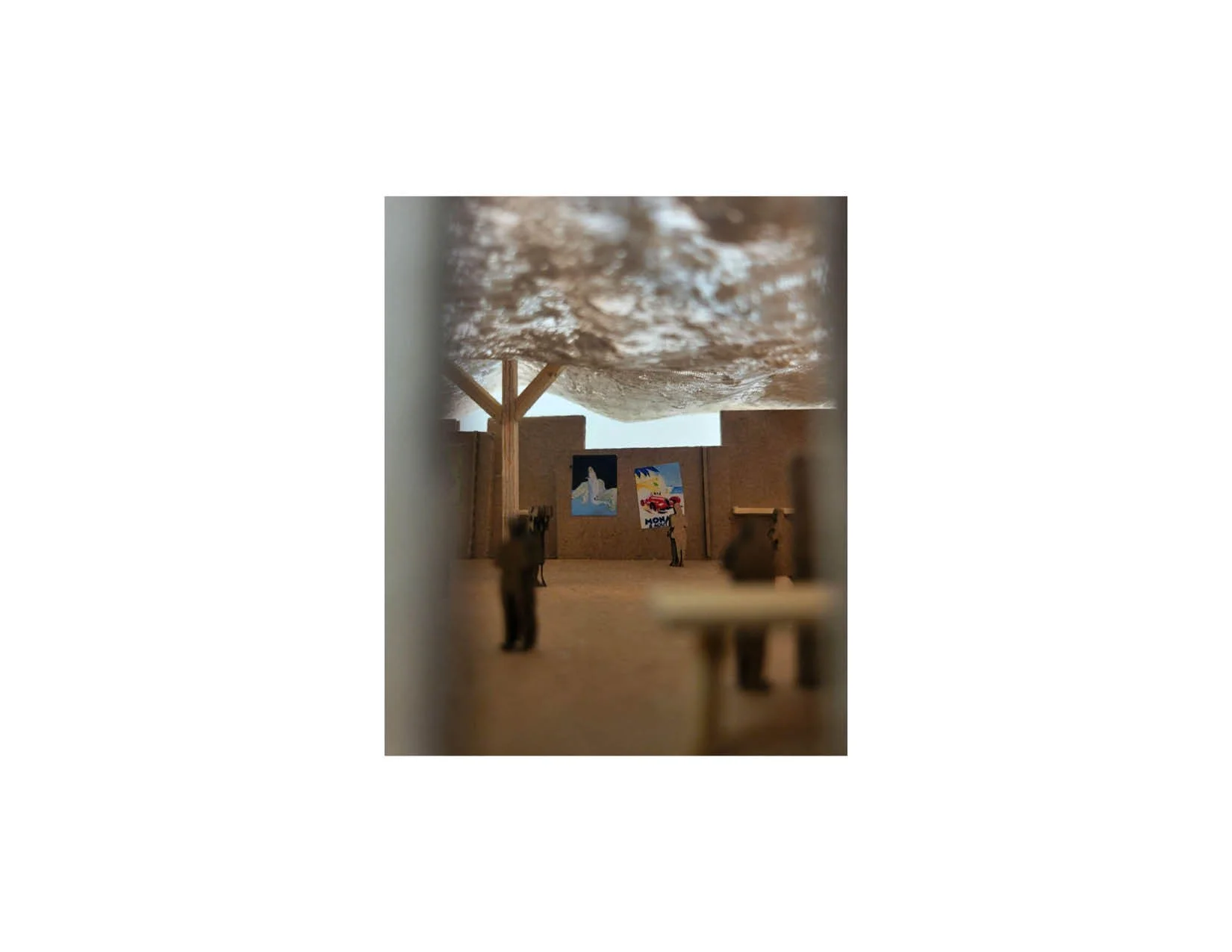 Miniature art gallery with animal sculptures and colorful paintings on the walls.