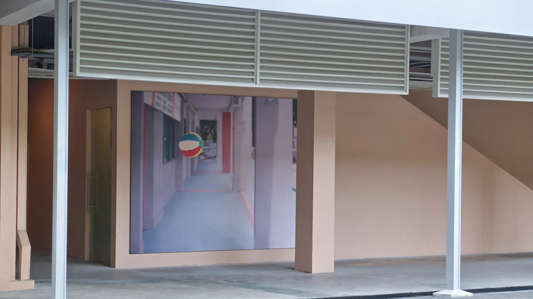 A large mural of a sidewalk with a striped beach ball hanging from a pole outside a building.