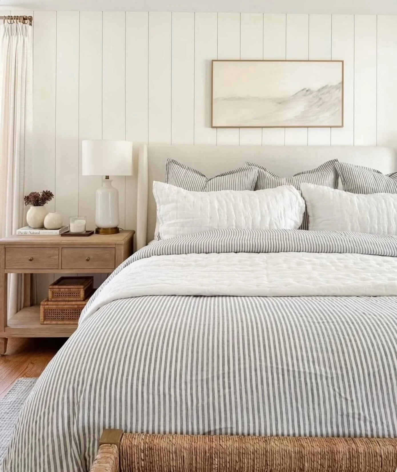 A good example of how subtle pattern can add interest without disrupting a calm scheme.

The narrow stripe works beautifully here against the vertical panelling and soft tonal palette - enough contrast to create depth, while still keeping the space f