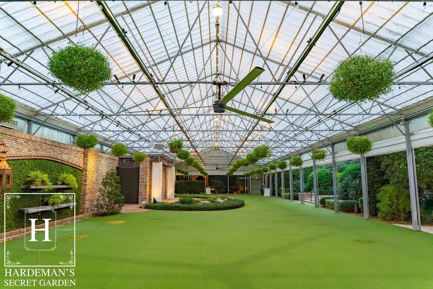 Bright and inviting, the Orchid House features a transformative roof that opens the space beautifully, paired with complementary hanging flower baskets that add color and charm overhead.

hardemanssecretgarden.com
#hardemanssecretgarden #wedding #wed