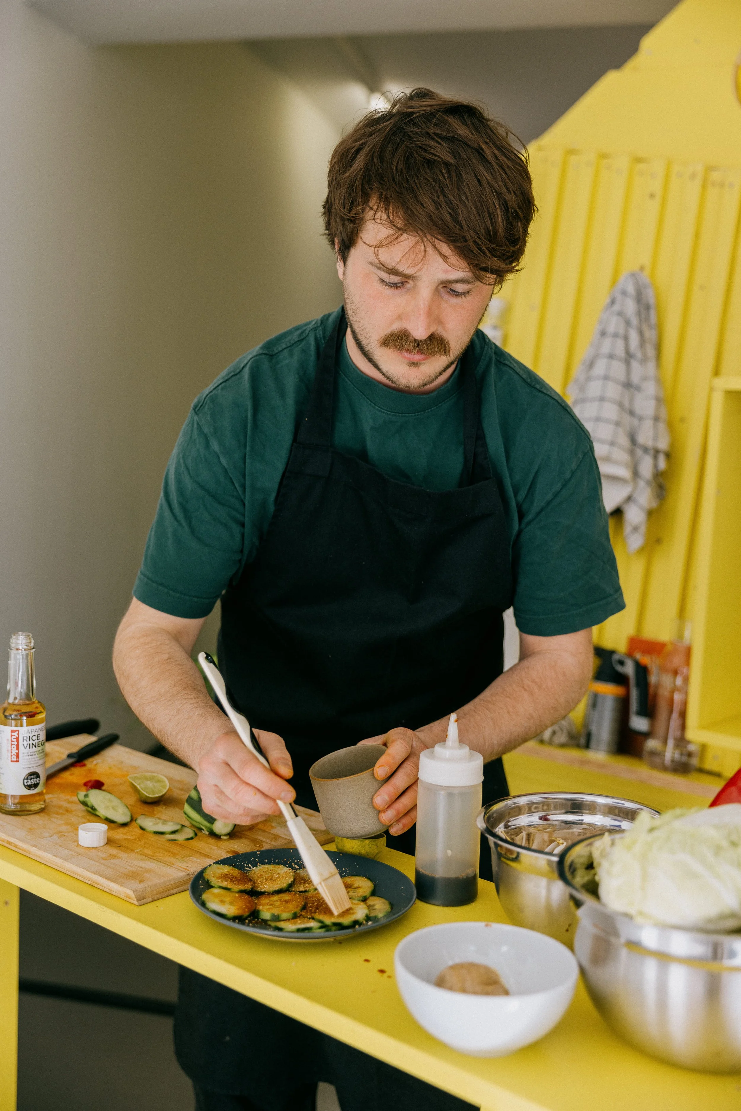 Fergus Tibbs preparing food in fotogalleriet for art gallery visitors.