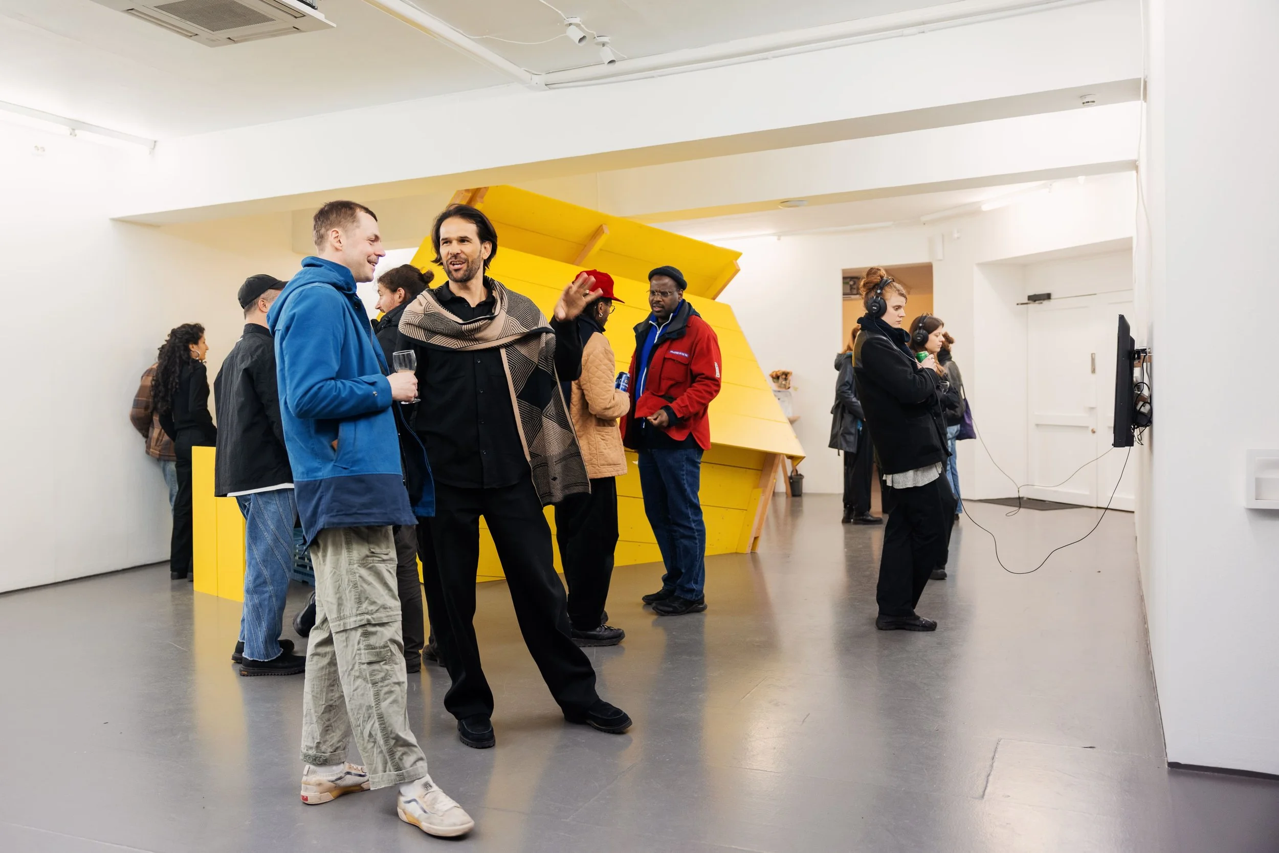 People gathering during opening of exhibition with imbiss by Fergus Tibbs