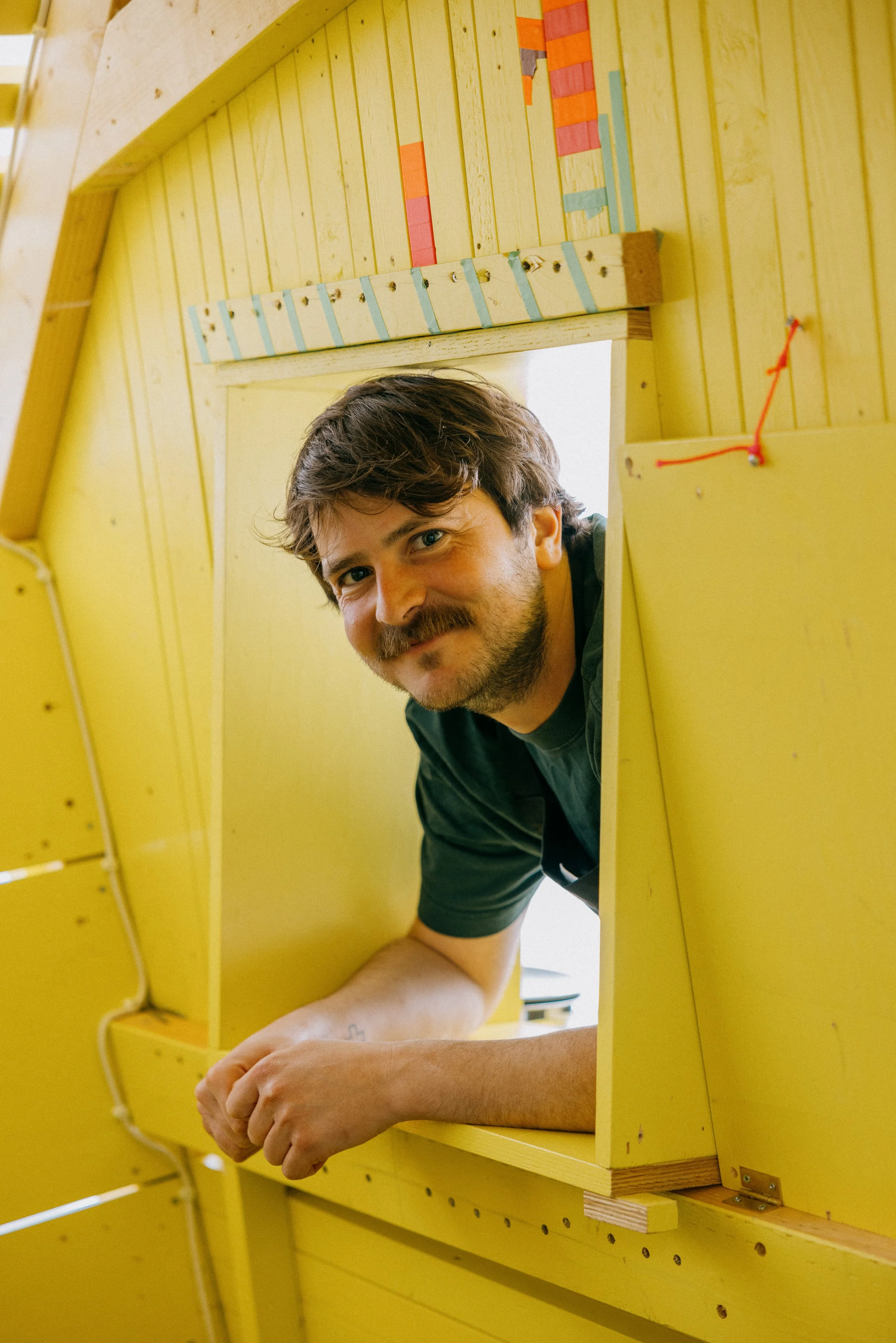 Portrait of Fergus Tibbs artist inside his installation at fotogalleriet oslo
