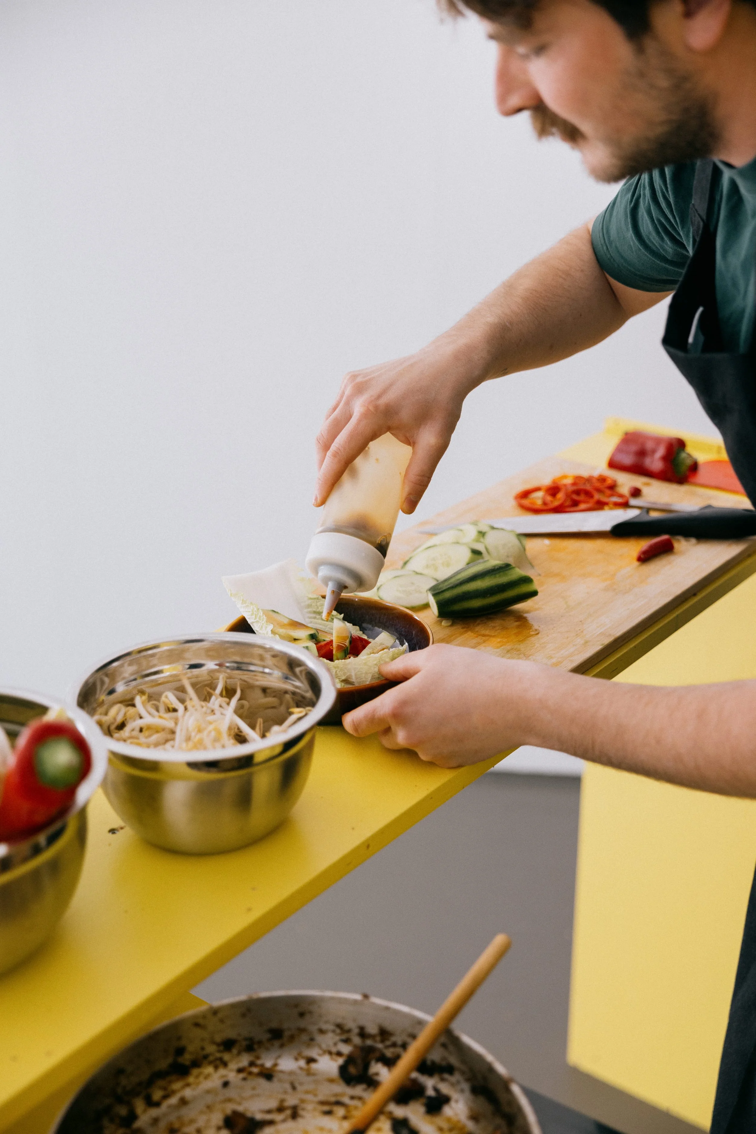 Fergus Tibbs artist cooking food inside the gallery