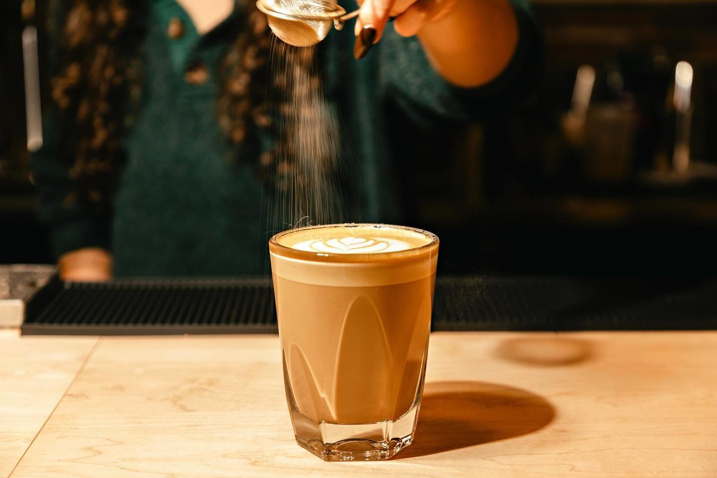 Drizzling some maple sugar on our new maple cardamom latte. Here for a great time, not a long time so come try it while you can!