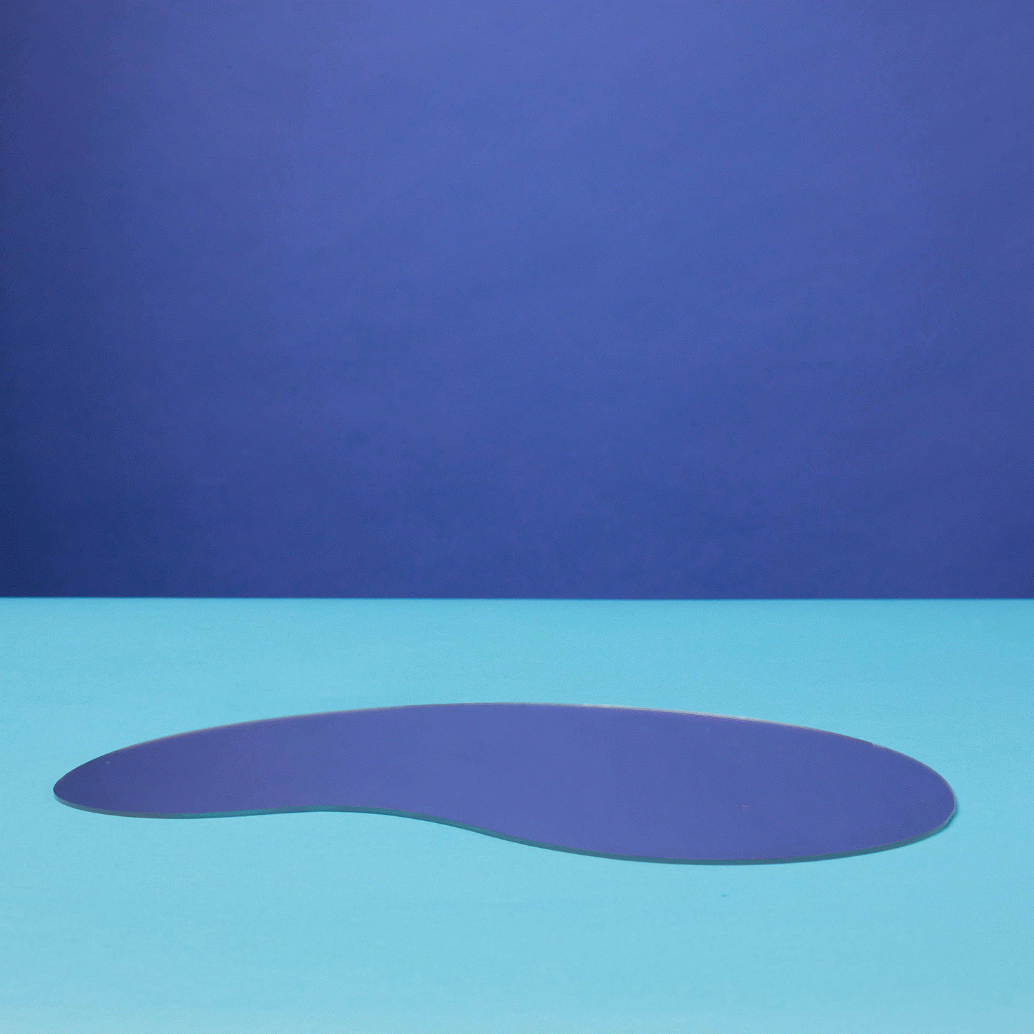 Stop motion GIF of children's yellow rain boots walking across light blue floor with dark blue background.