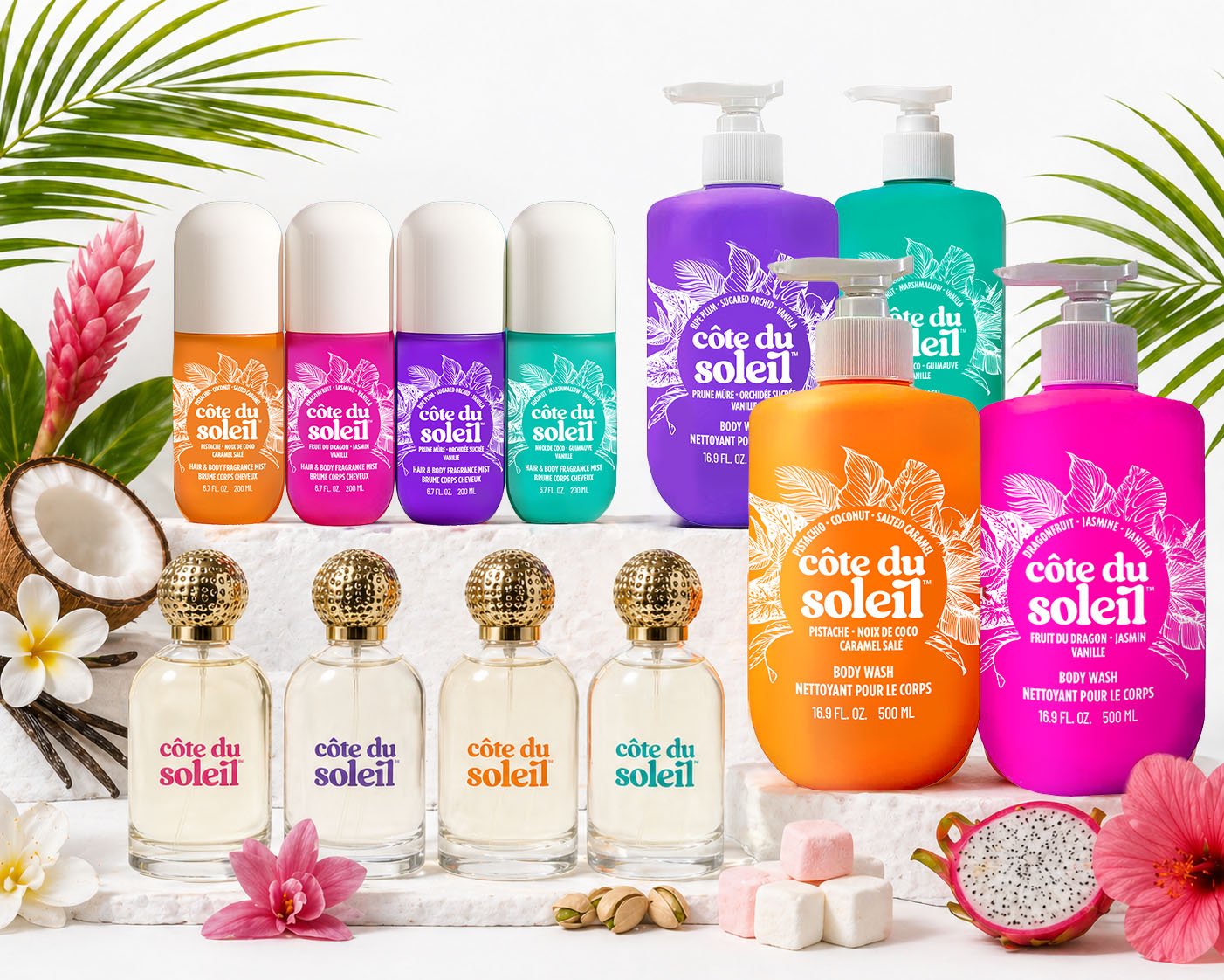 Assorted Côte du Soleil body washes and fragrances with tropical flowers, coconuts, and dragonfruit in a tropical-themed display.