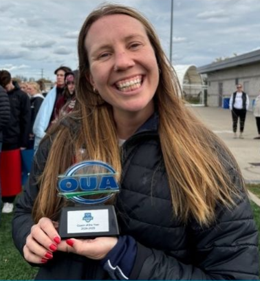 Coach Jesse Porter from the Safe Sport Lab at U of T holding her award for UOA Coach of the Year! 