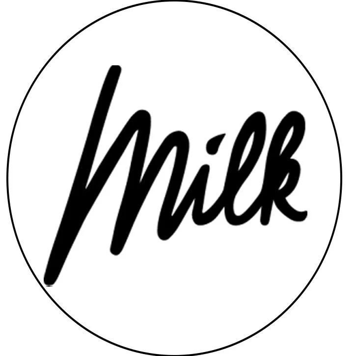 Logo noir avec le mot « Milk » écrit en style cursif sur fond blanc.