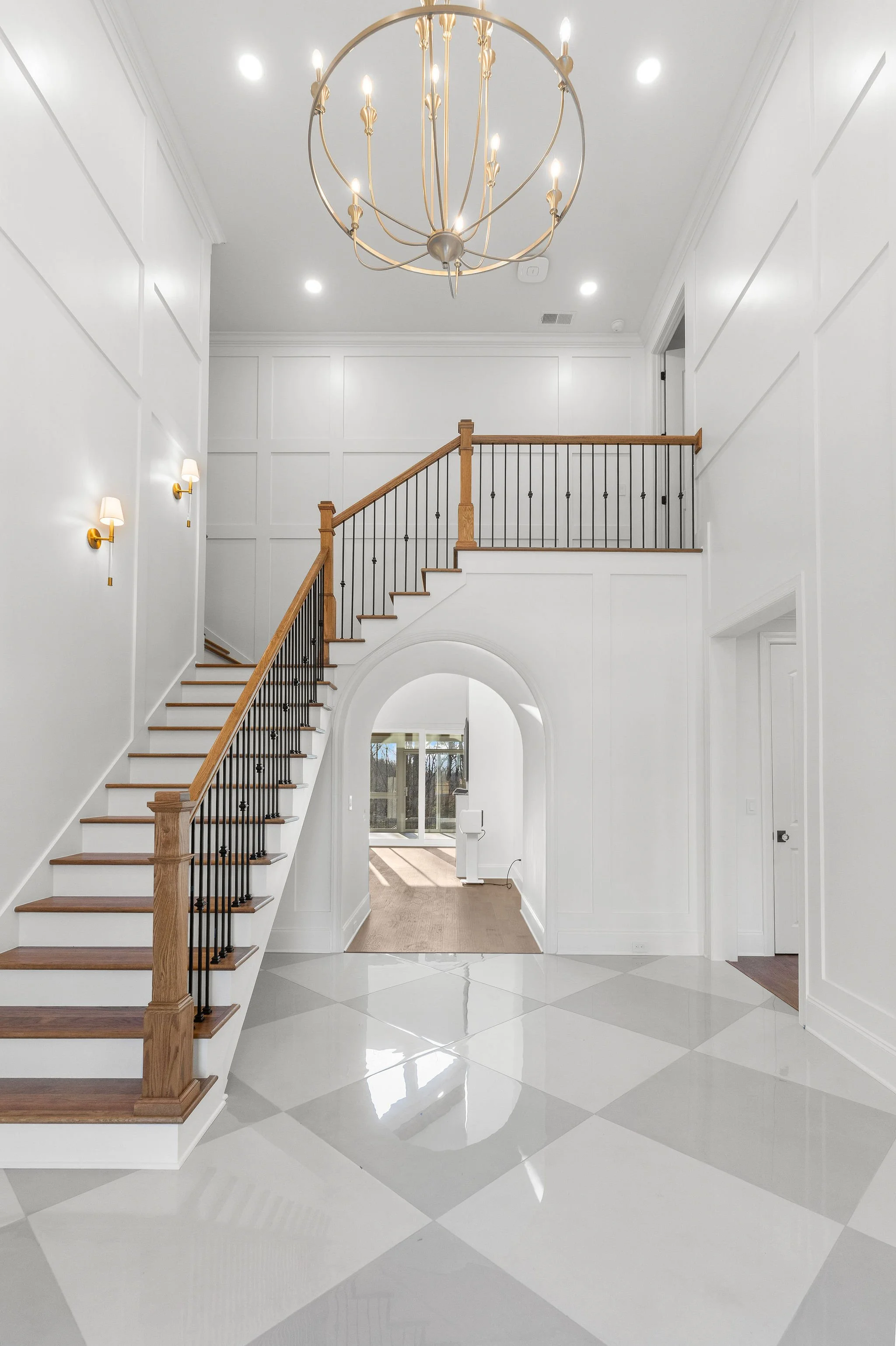 Elegant foyer in a custom home in Chattanooga TN featuring a grand staircase, high ceilings, and modern finishes by a luxury home builder in North Shore.