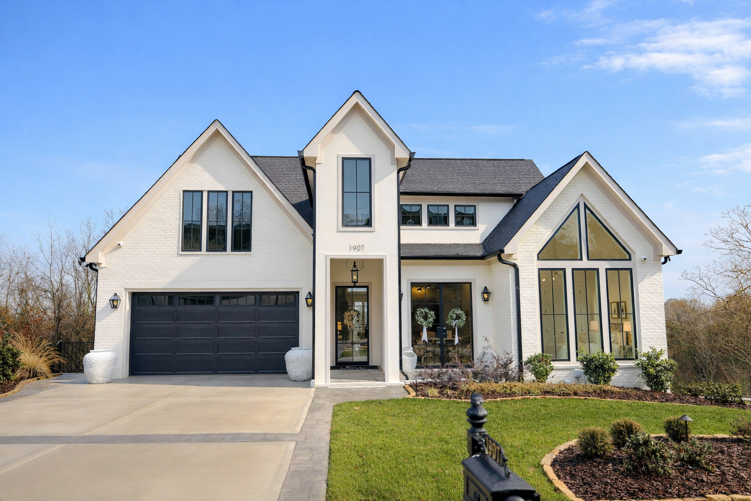 Elegant custom home exterior in Chattanooga TN featuring modern farmhouse design, black-framed windows, and a spacious front elevation by a luxury home builder in North Shore.