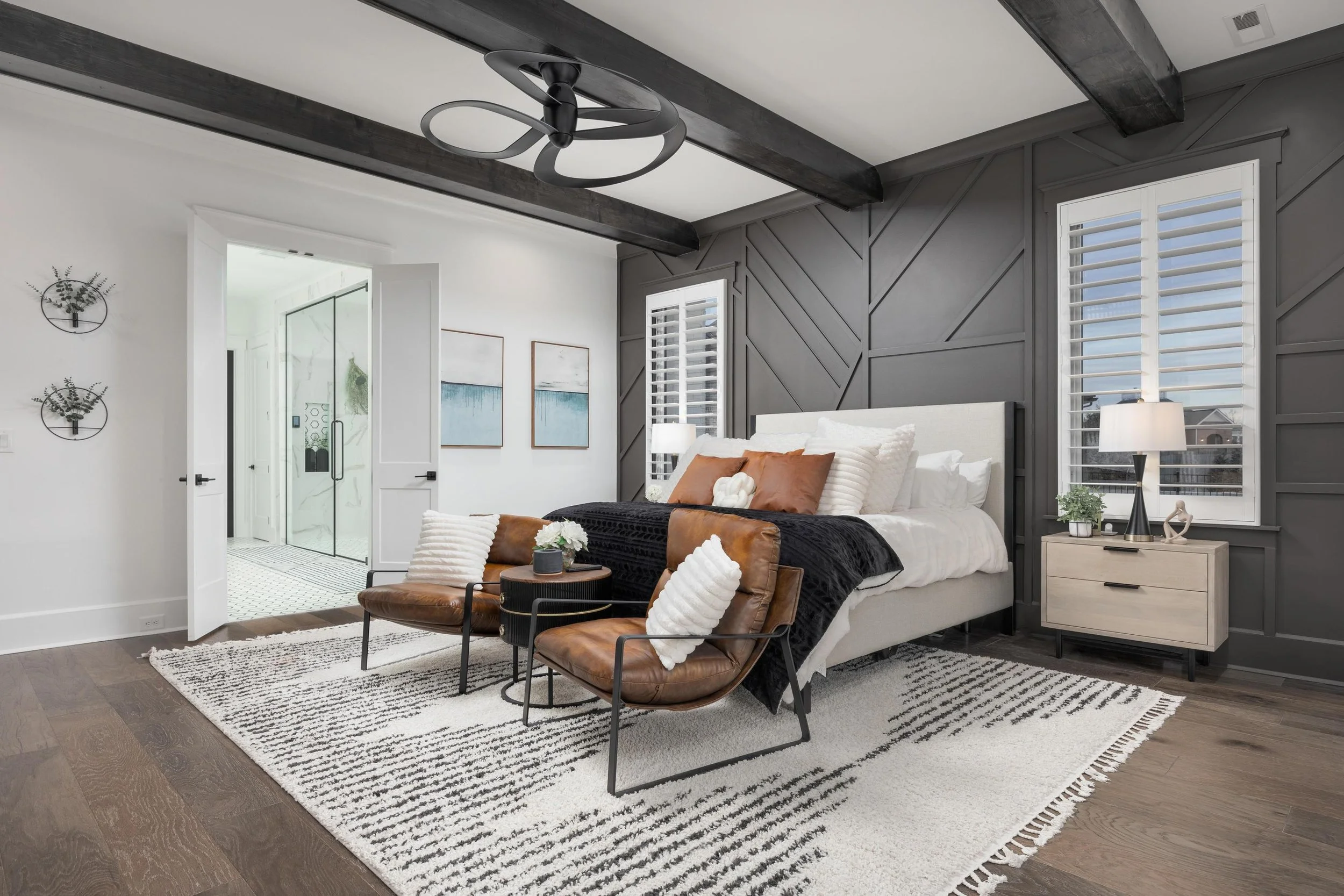 Spacious primary bedroom in a custom home in Chattanooga TN featuring exposed beams, modern lighting, and a spa-like ensuite for elevated everyday living.