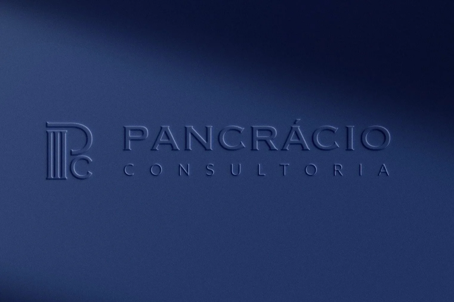 Embossed blue logo with the words 'PANCÁRCIO CONSULTORIA' and a stylized letter 'P' on a blue background.