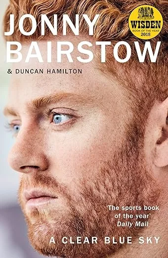 Close-up of a book cover featuring a side profile of a man with red hair and a beard, with text indicating the title 'Jonny Bairstow' and other details.