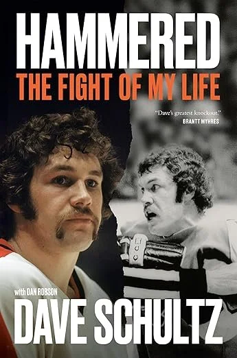 Book cover for 'Hammered: The Fight of My Life' by Dave Schultz, featuring a color photo of Dave Schultz with a mustache and curly hair, and a black and white photo of a young man with curly hair, both wearing wrestling uniforms.