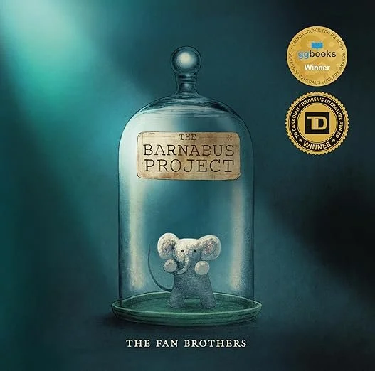 A book cover titled 'The Barnabus Project' by The Fan Brothers, featuring a small creature inside a glass jar with a label, set against a dark background with award stickers.