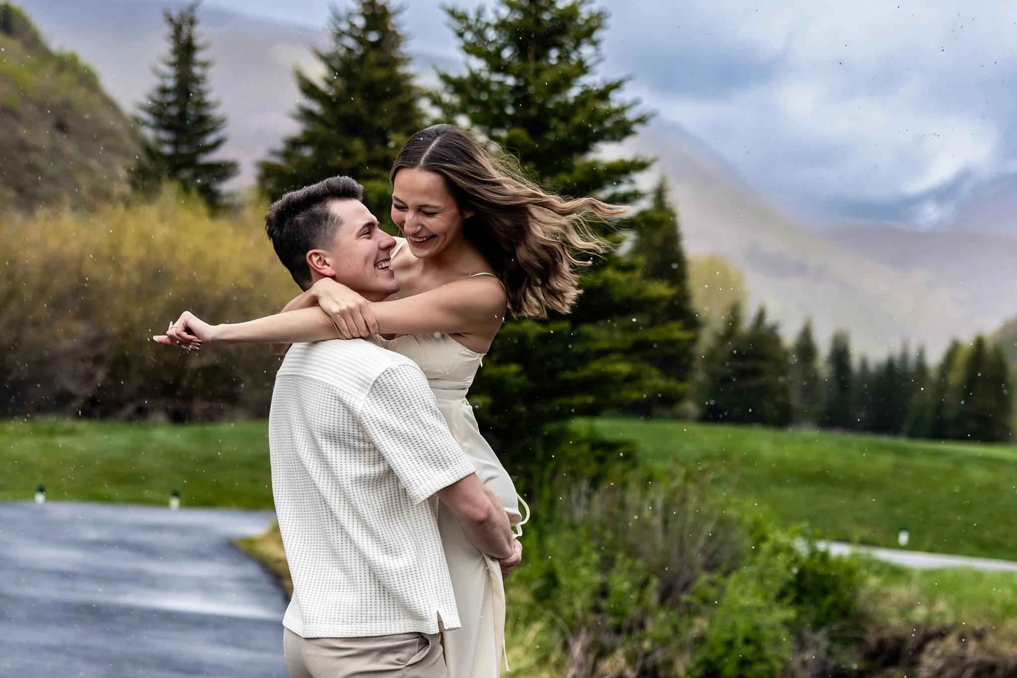 Young couple holding each other at a lake in Colorado on their elopement day