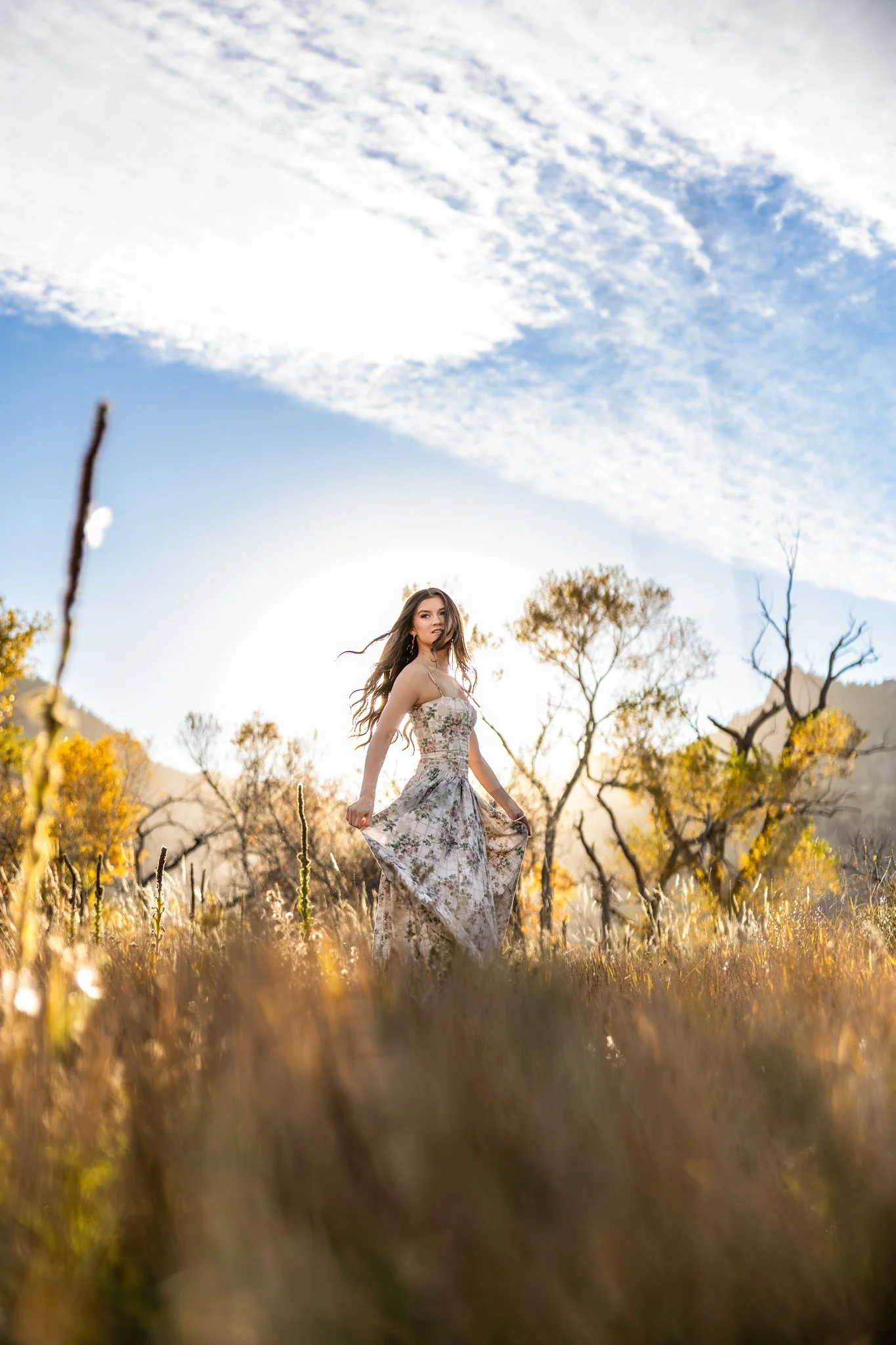 Fine Art High School Senior Photographer captures portrait of senior girl spinning in a field
