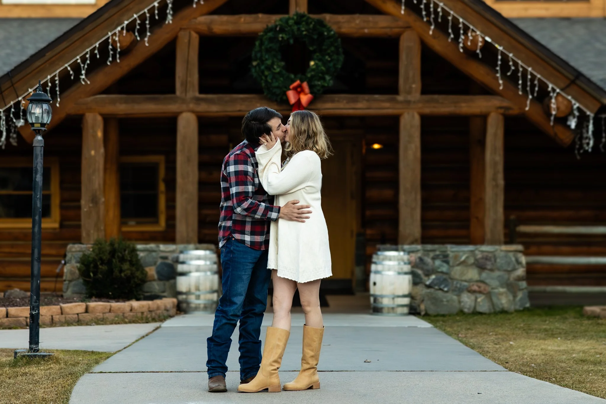Couple kissing in front of the Evergreen Lake House photograph taken by Kim Graves Photography.