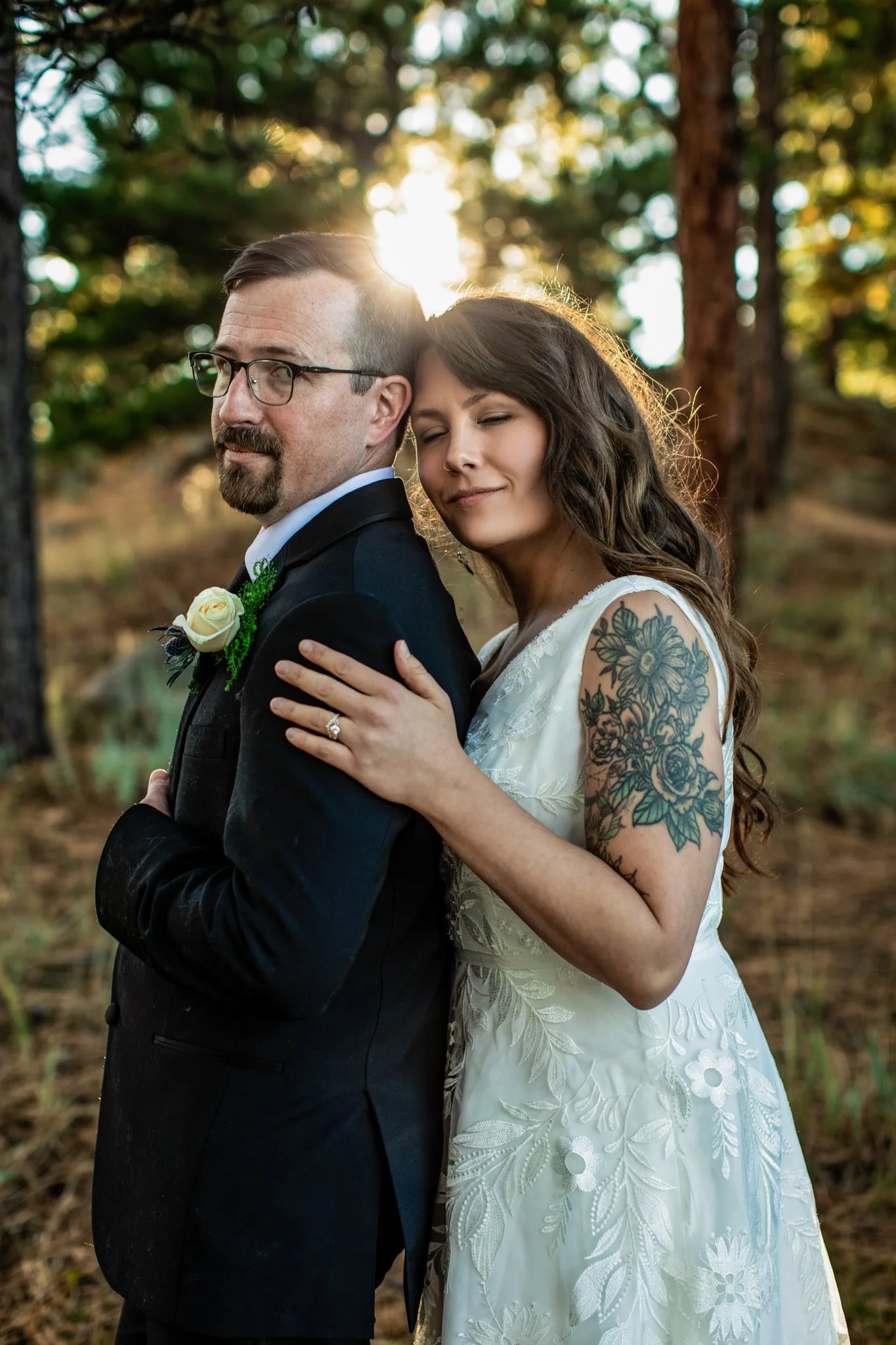 Young couple holding each other at a lake in Colorado on their elopement day
