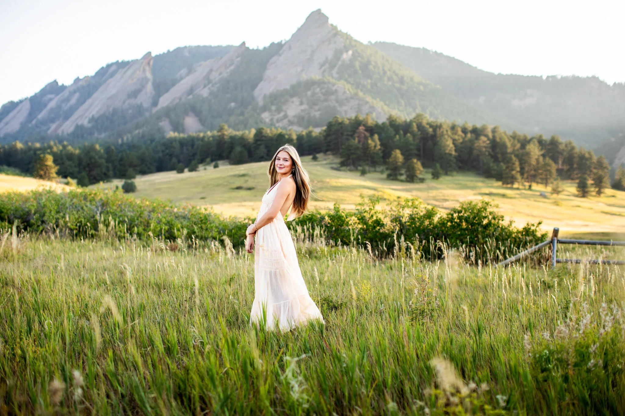 Boulder High School Senior Photographer captures photograph of a high school senior girl standing in front of the flatirons at Chautauqua Park in Boulder.