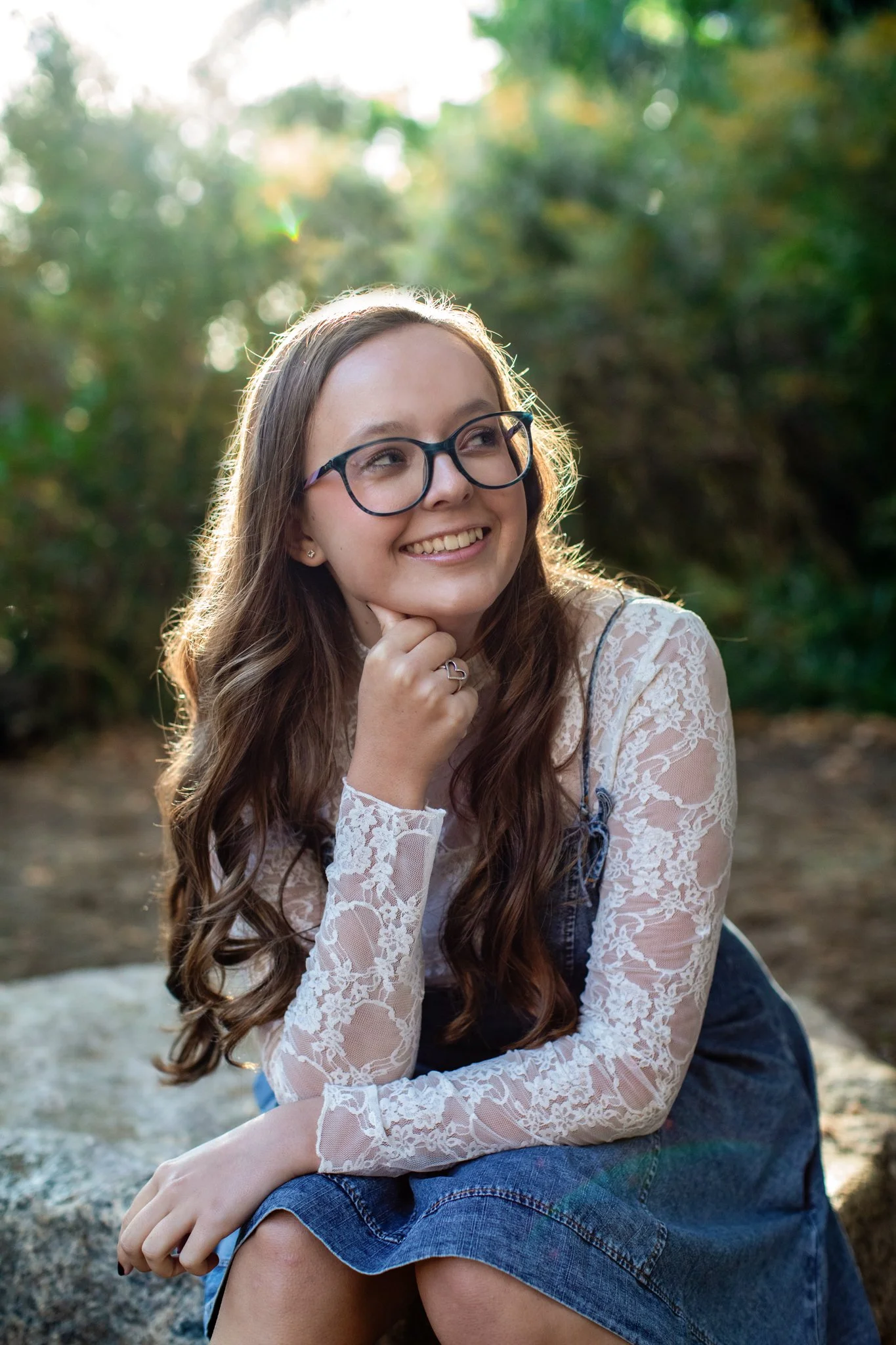 Golden Colorado High School Photographer captures picture of girl in white lace top under short denim dress.