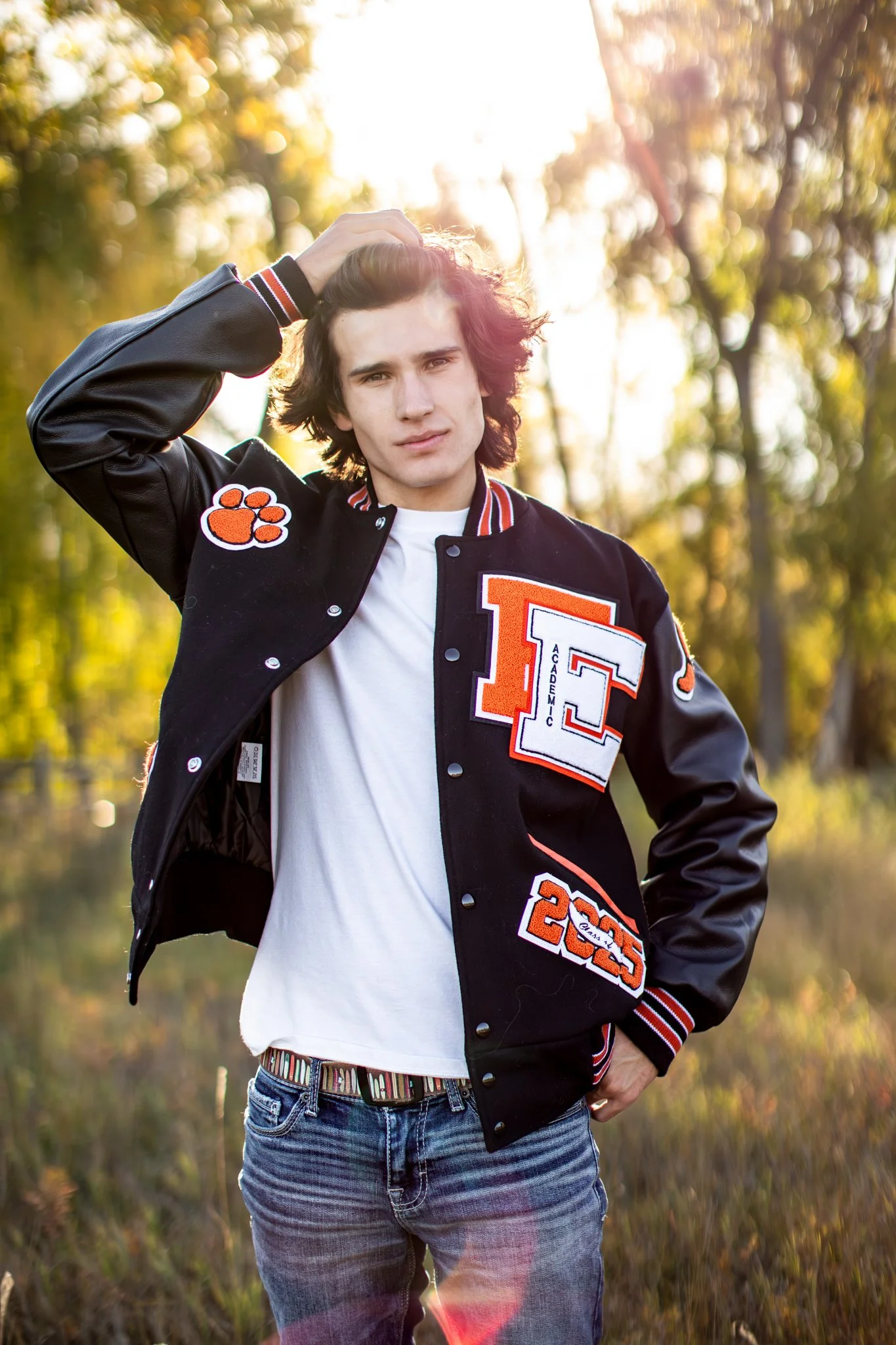 Boulder Colorado High School Senior Photographer takes portrait of young man in letter man jacket.