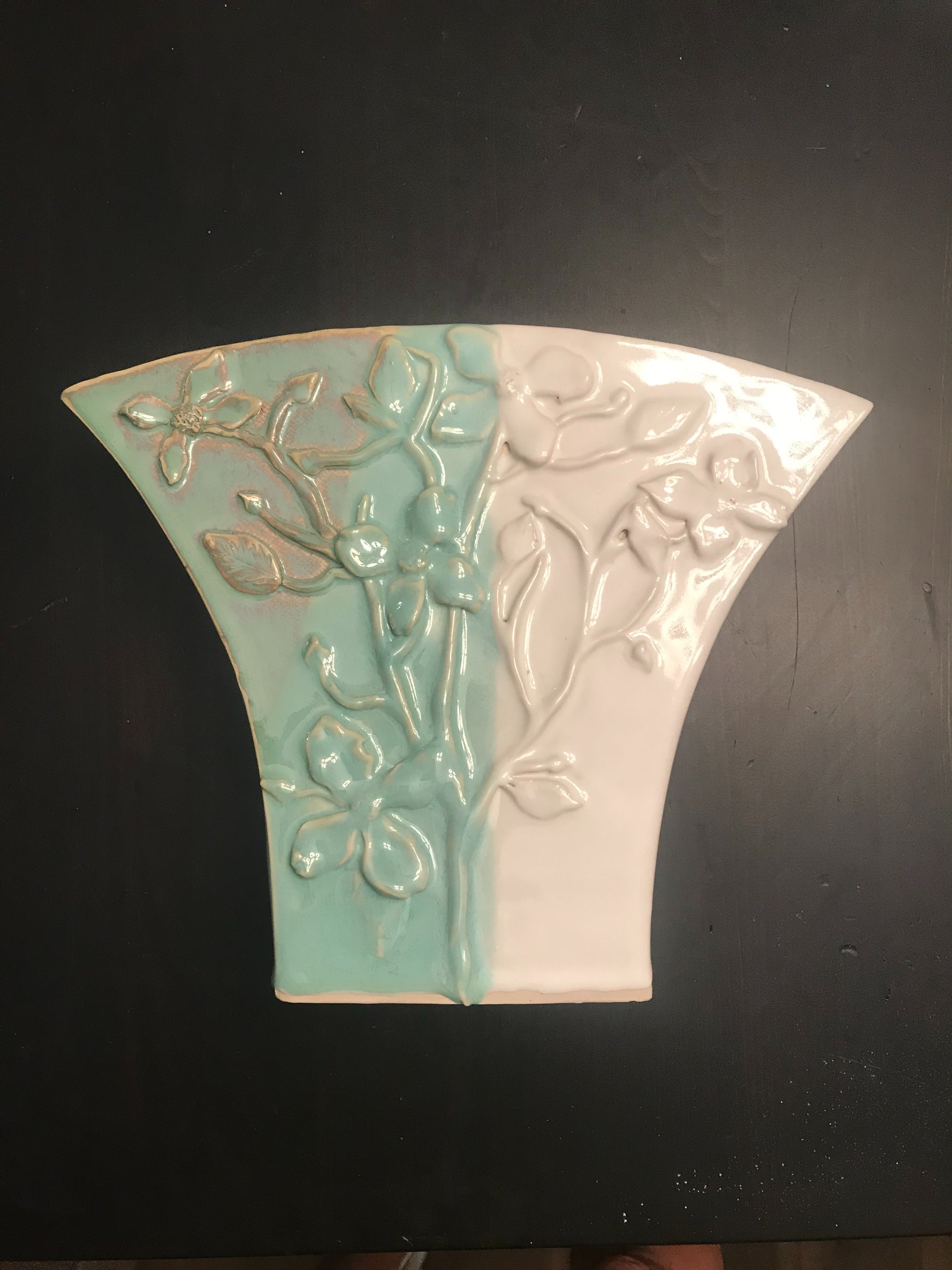 Handbuilt base glazed white and turquoise with flower motif