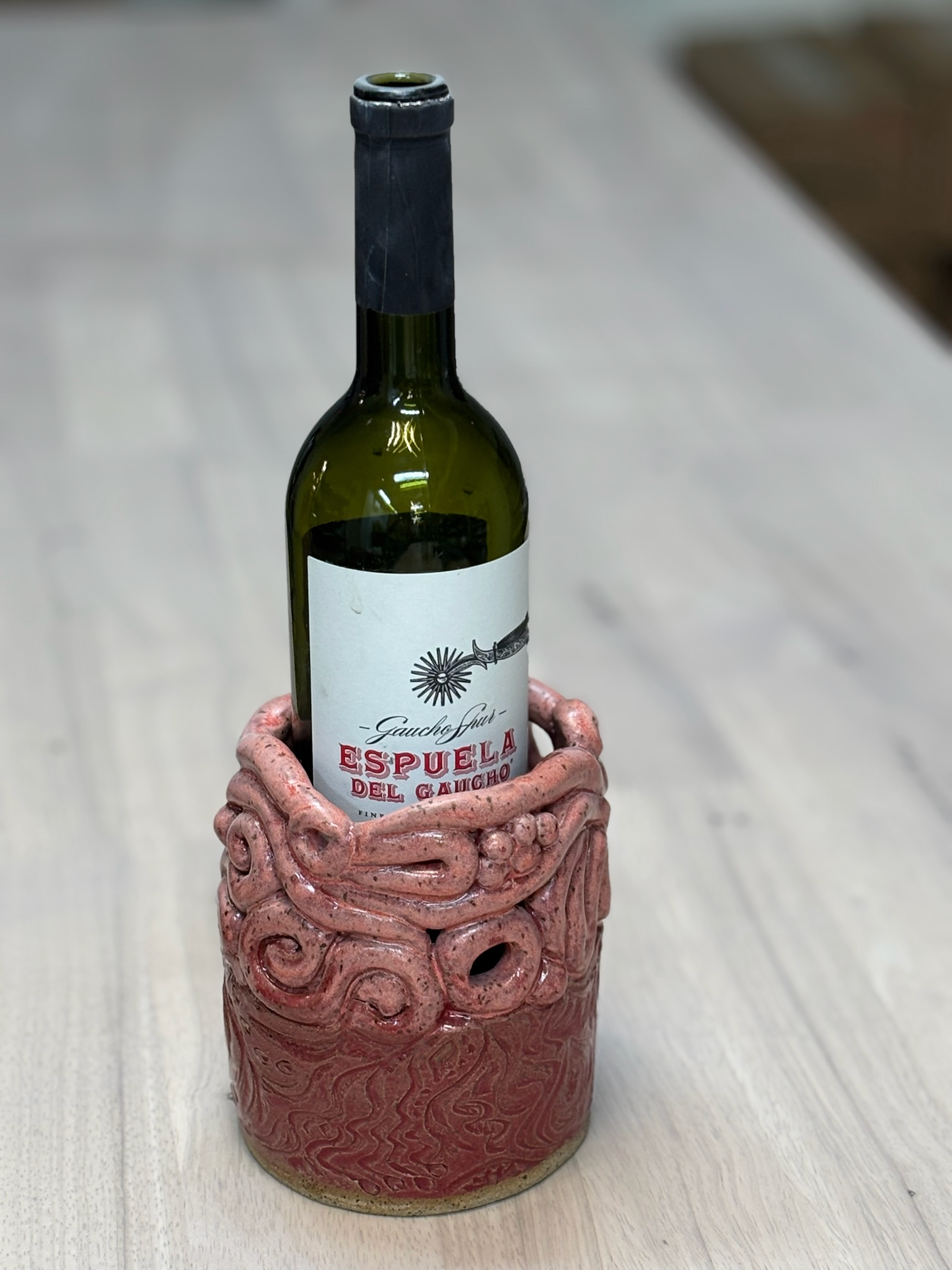 A bottle of wine in a clay container