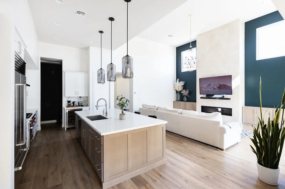 a kitchen and living room with wood floors