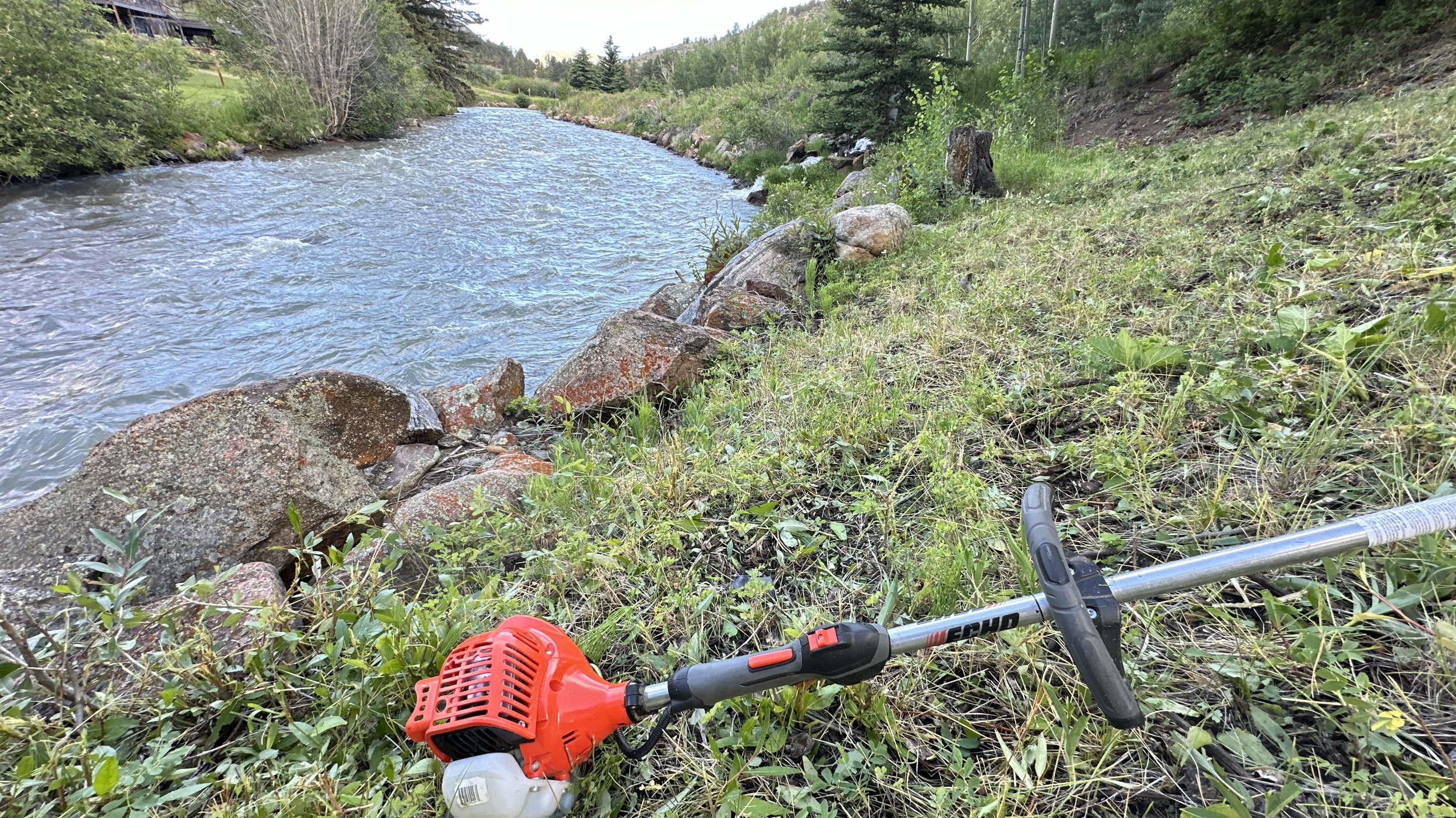 Weed eating along a beautiful Platte River property.