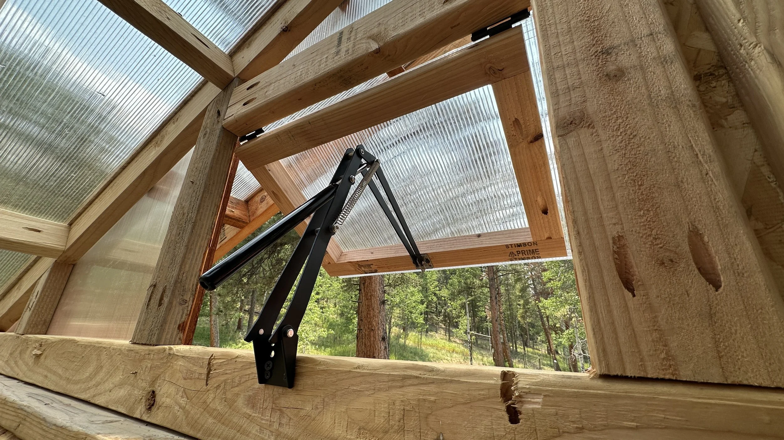 Automatic vents that use a piston filled with beeswax to automatically open and close depending on temperature. This build has 2 of these vents down low and 2 up high to move air when it gets hot.