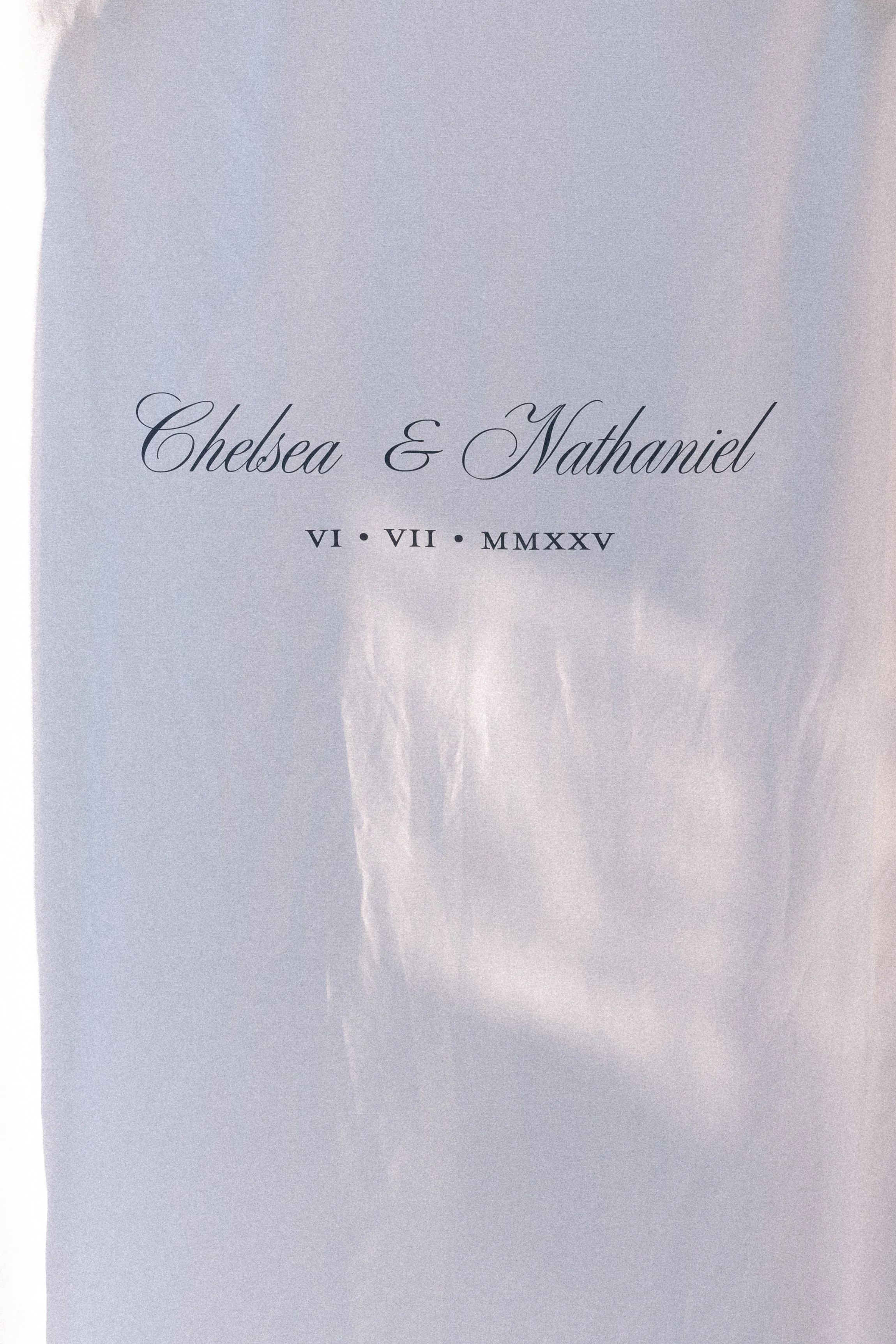 Wedding invitation with the names 'Chelsea & Nathaniel', date written in Roman numerals VI • VII • MMXXV, on a white background.