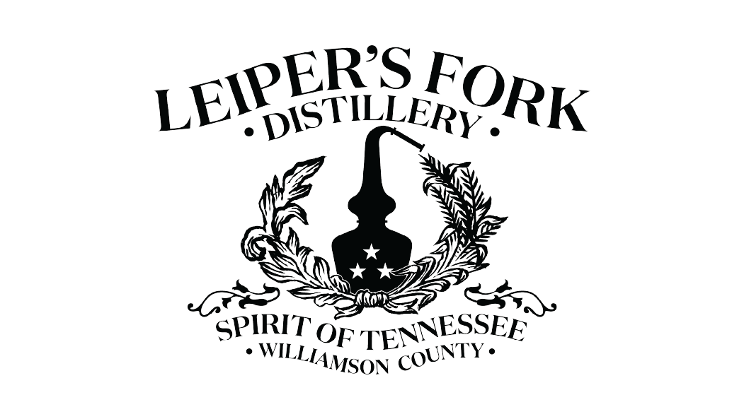Logo of Leipers Fork Distillery featuring a still with a pipe, surrounded by laurel leaves, and text indicating 'Leipers Fork Distillery,' 'Spirit of Tennessee,' and 'Williamson County'.