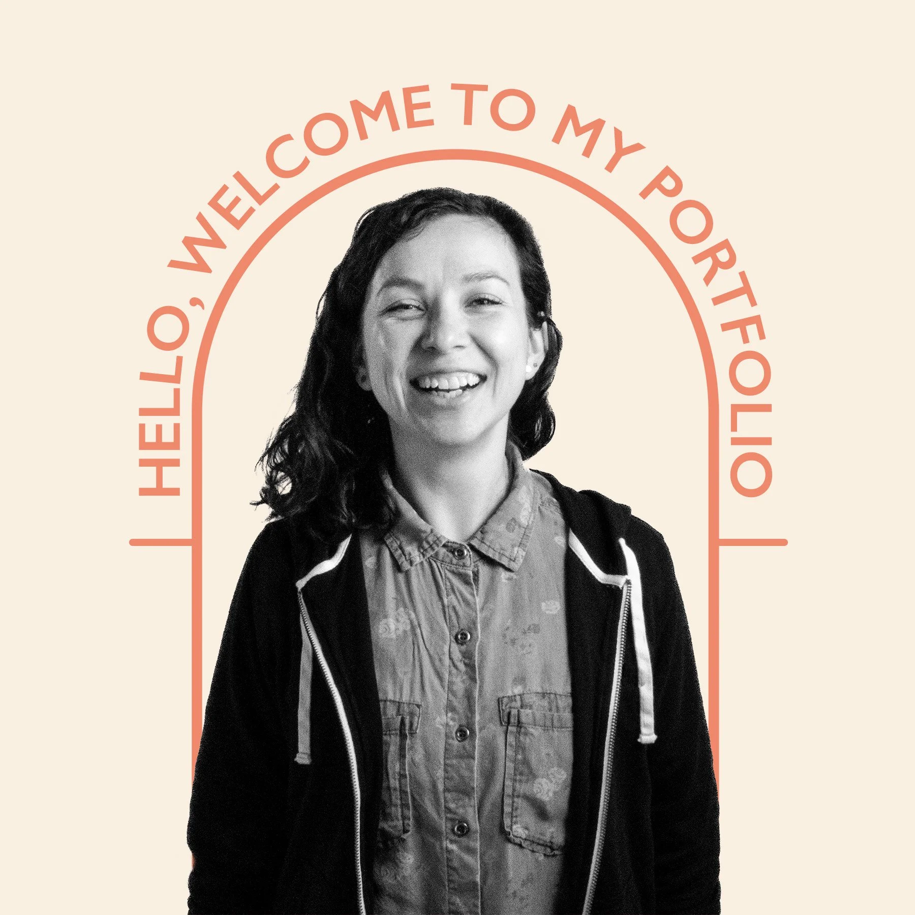 A smiling young woman with curly hair wearing a patterned button-up shirt and a black zip-up hoodie, standing in front of a beige background with red text above her that reads, "Hello, welcome to my portfolio."