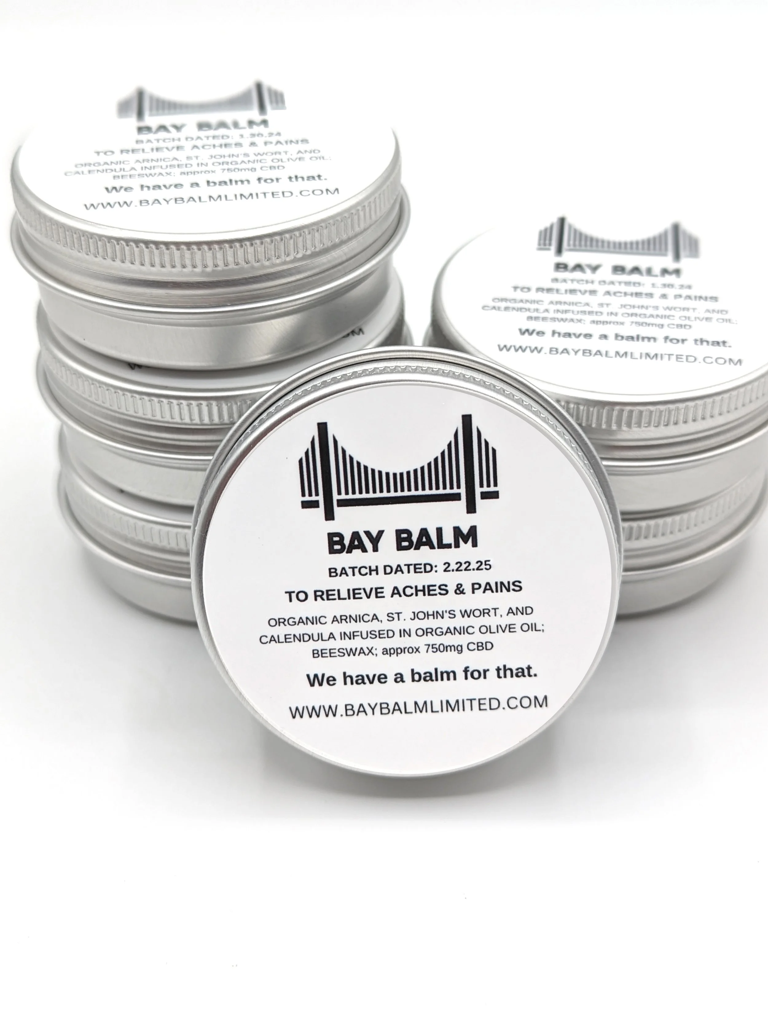 Baybalm product with its packaging. The labels mention ingredients like organic arnica, St. John's wort, calendula, olive oil, beeswax, and CBD, and state that the balm relieves aches and pains.