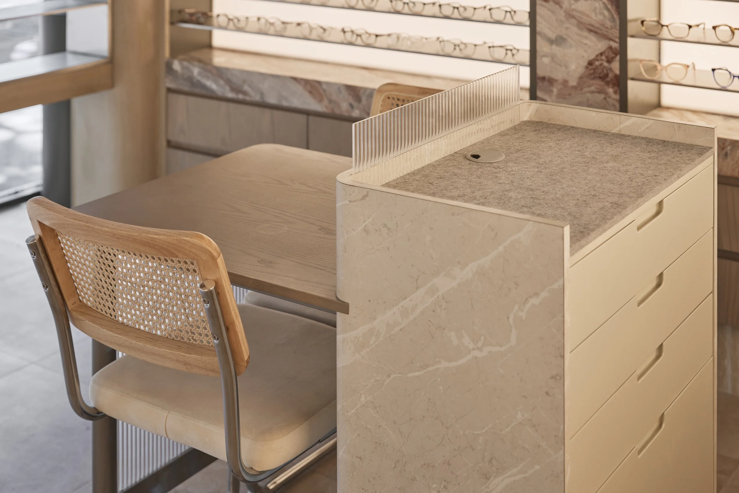 Bright Eyes Optics Mona Vale retail fit-out featuring custom stone joinery, precision cabinetry, fluted glass detailing and warm timber finishes – Sydney City Renovations.
