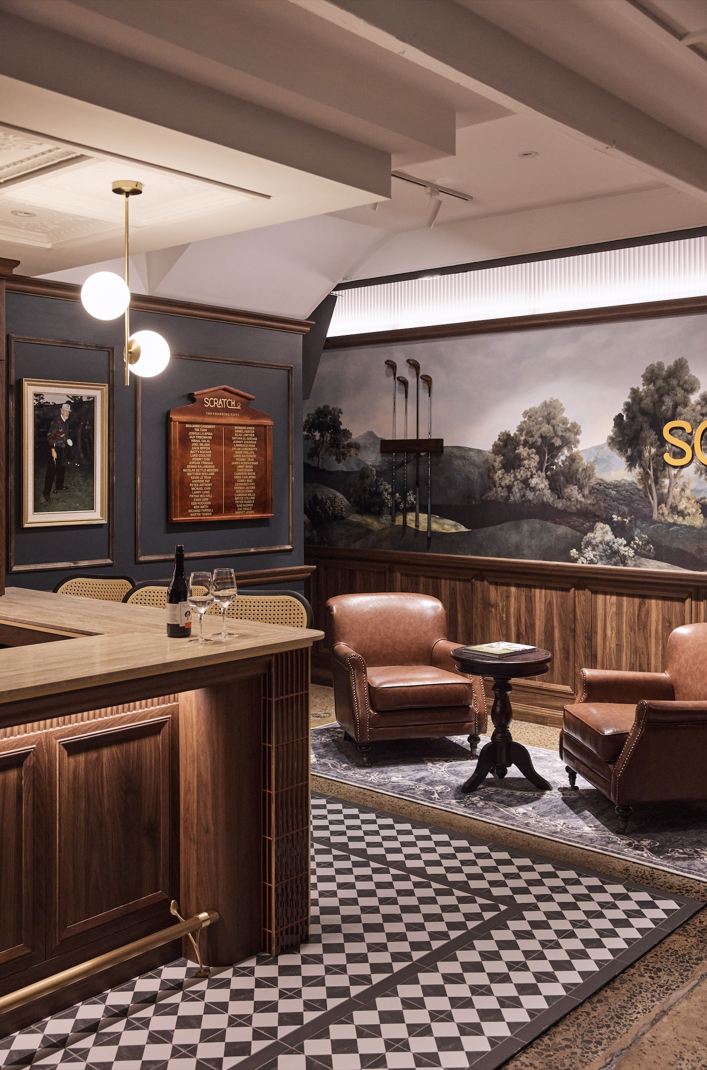 Scratch Golf Studio Marrickville commercial fit-out featuring bespoke timber bar joinery, illuminated shelving, decorative wall panelling, leather lounge seating, geometric floor tiles and custom golf-themed wall graphics – Sydney City Renovations.