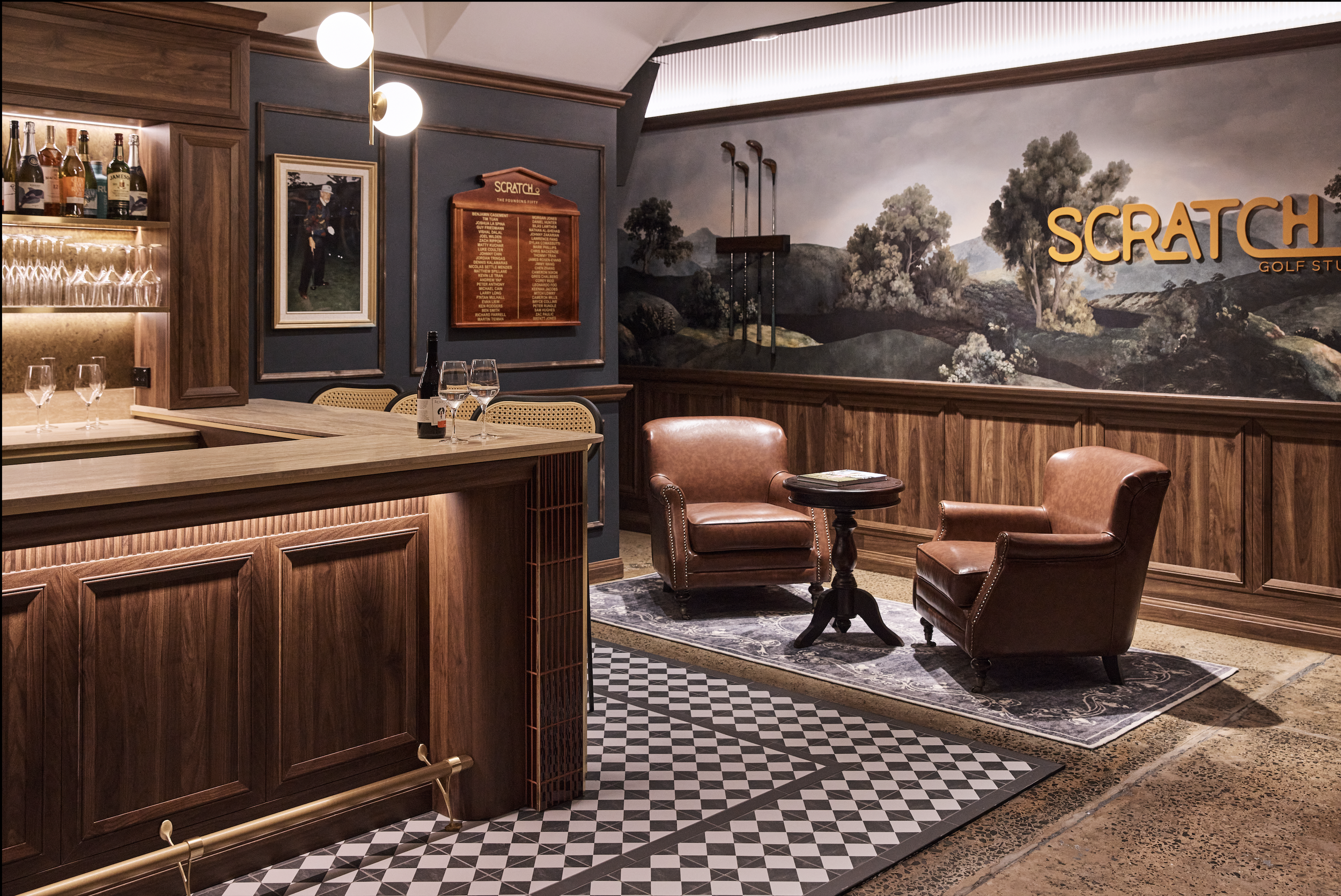 Scratch Golf Studio Marrickville commercial fit-out featuring custom golf-themed wall graphics, illuminated signage, decorative timber wall panelling, vintage leather lounge seating and geometric floor tiles – Sydney City Renovations.