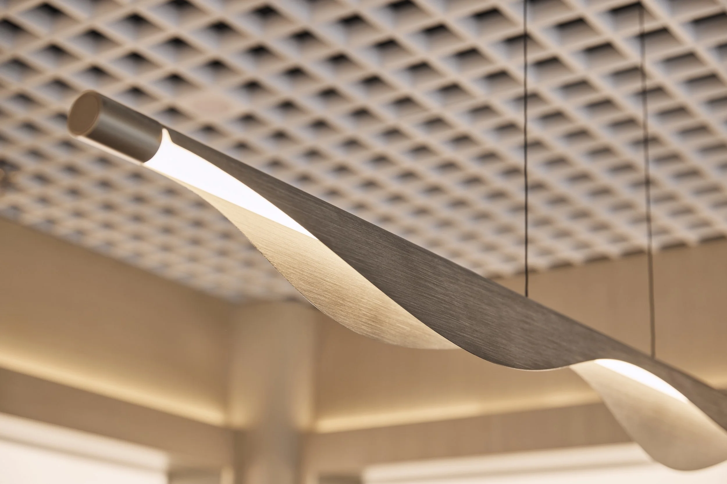 Bright Eyes Optics retail fit-out in Mona Vale, featuring a custom grid ceiling, sculptural suspended lighting and integrated LED illumination – Sydney City Renovations.