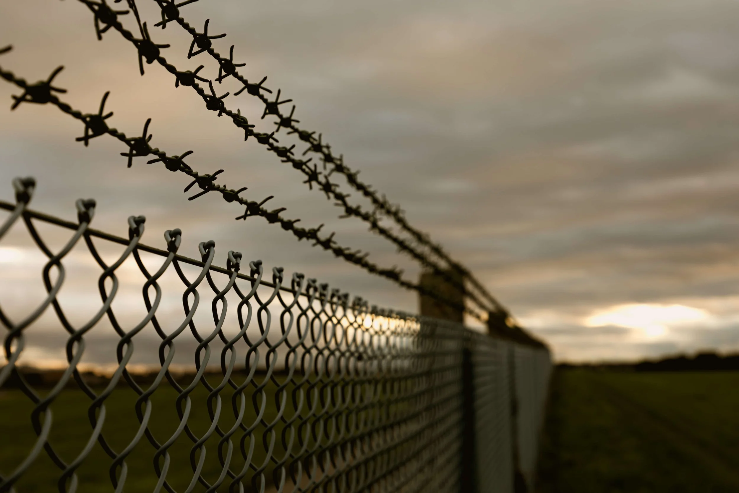 Close up of fence surrounding prison.
