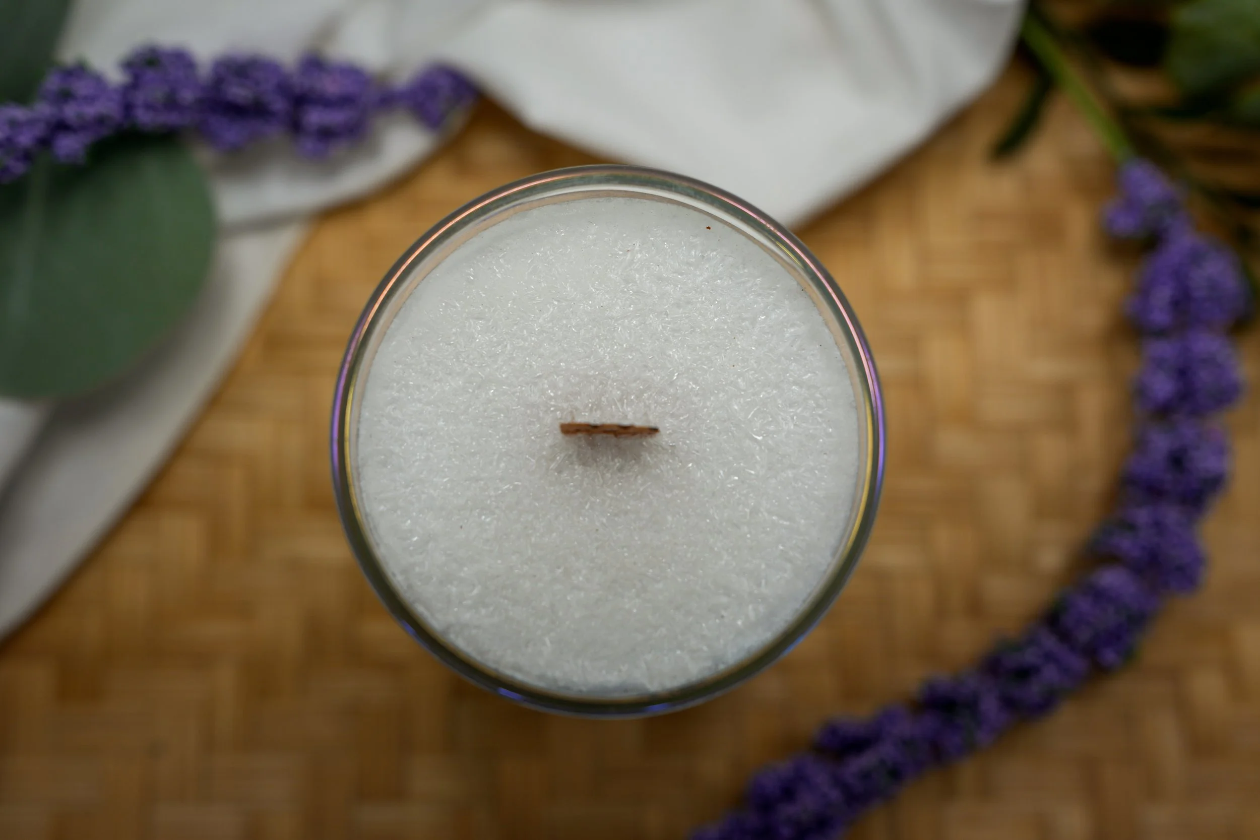 Top view of a palm wax candle showing its crystalline wax surface and centered wooden wick.