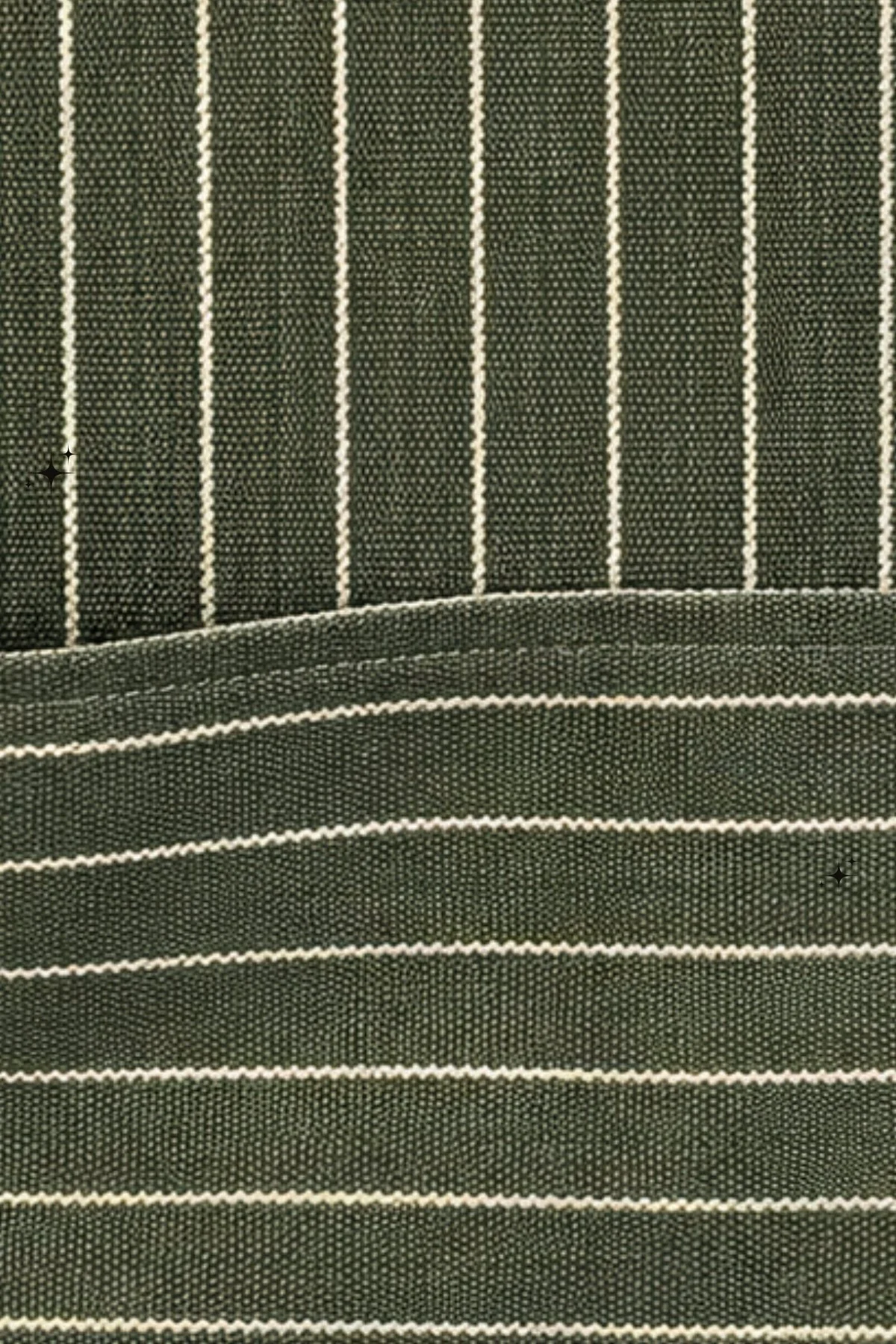 Close-up of olive-green apron fabric with fine cream stripes and stitching along the front pocket.