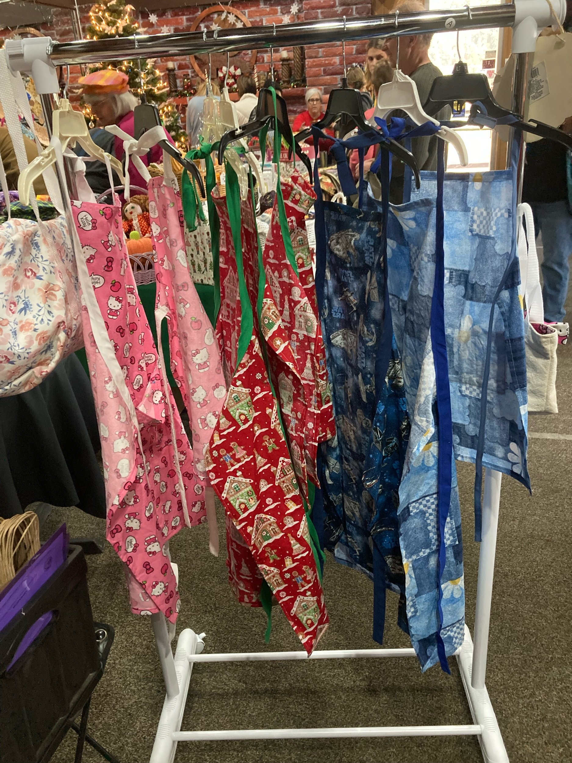 Adult size handmade is 35” long ties at the neck and waist. Adorned with a large pocket. Great for cooking and crafts. Machine washable, made with 100% cotton. Comes in a variety of styles.