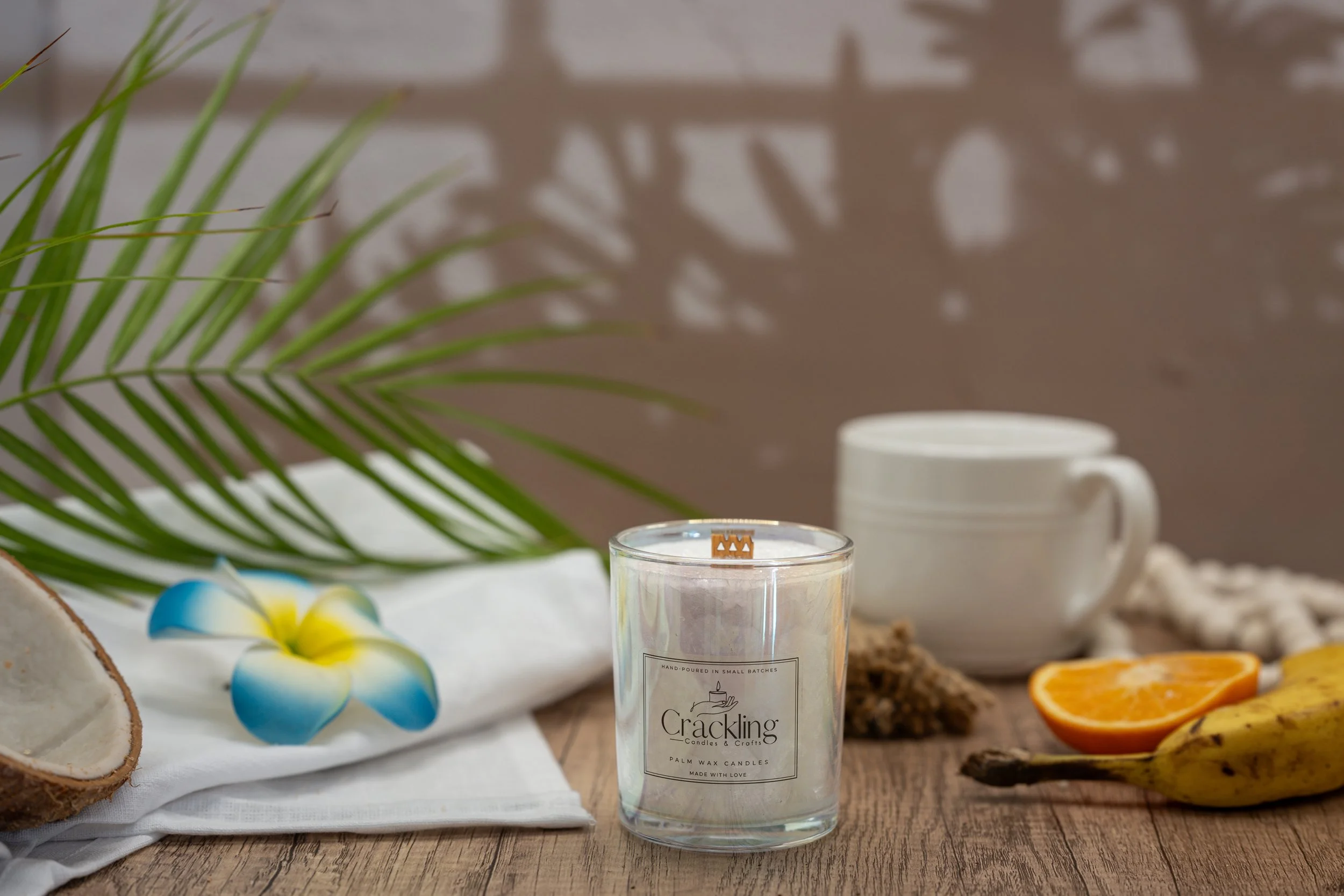 6 oz Café de Olla palm wax candle with a wooden wick, styled with a white coffee mug, cinnamon, citrus, and fresh greenery.