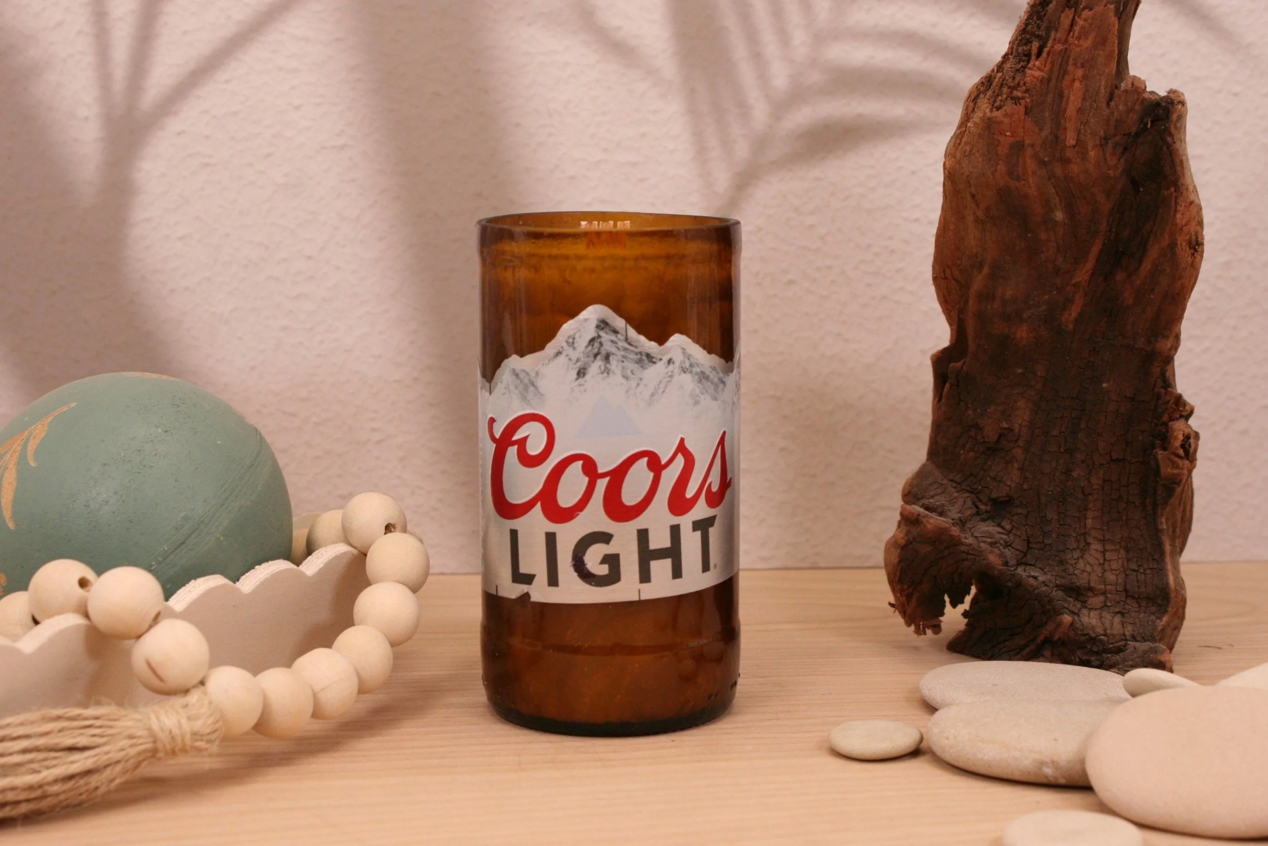 Our Coors Light Upcycled Beer Bottle Candle is a unique, eco-friendly piece that makes a perfect gift or a special treat for yourself.  Made to order with sustainable Palm Tree wax