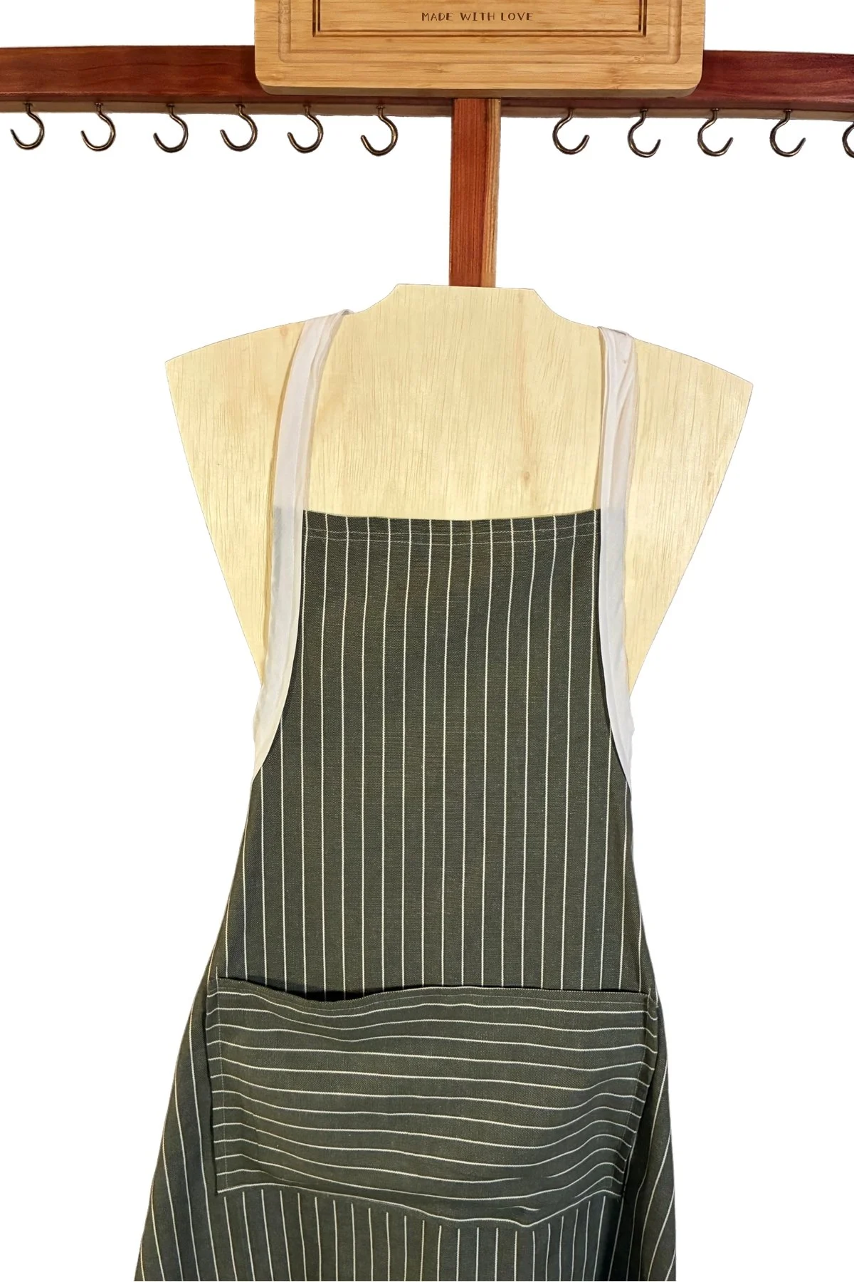 Men’s apron with fine cream vertical stripes and a front pocket with horizontal stripes.