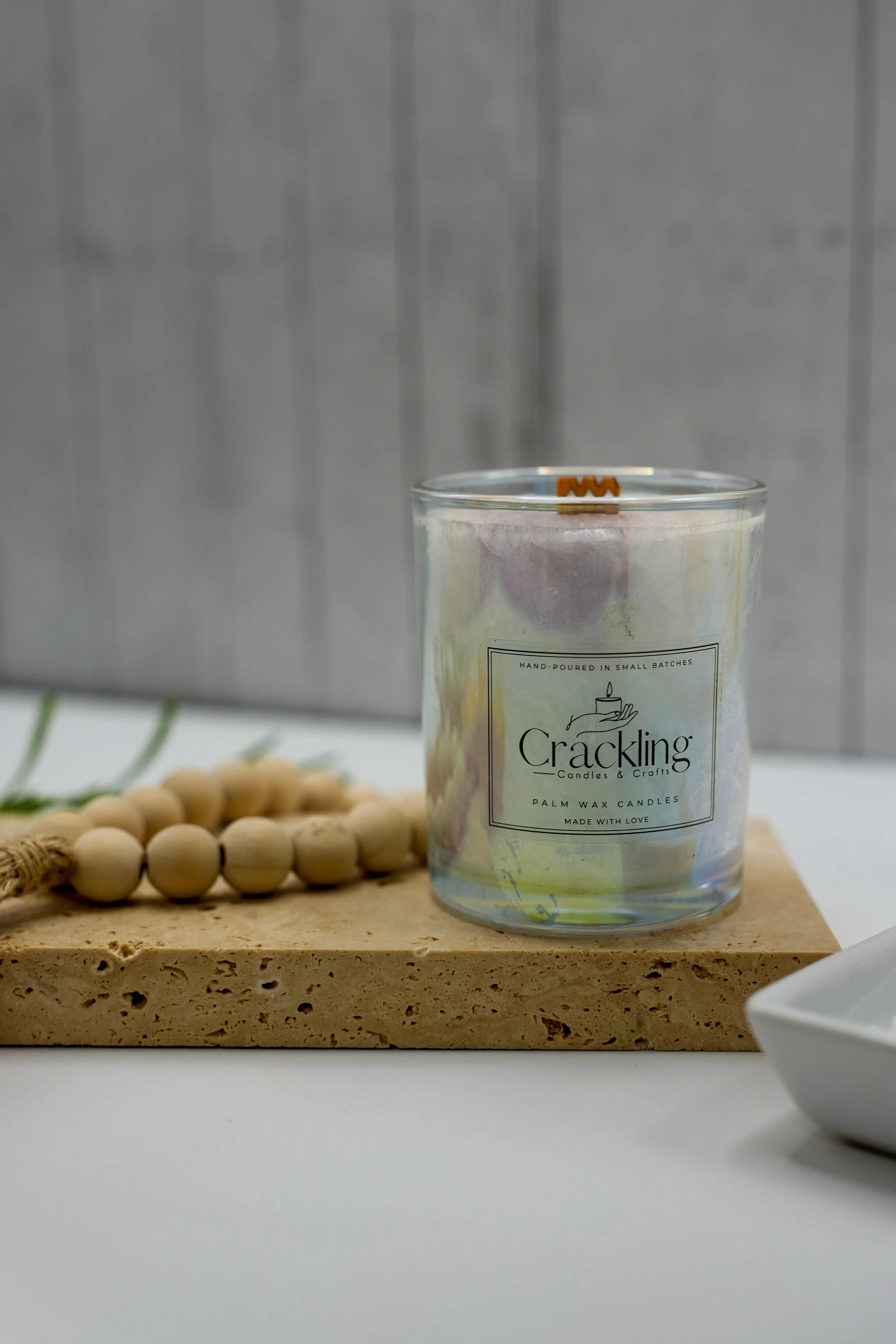 6 oz Island Mango palm wax candle with a wooden wick on a light wooden board