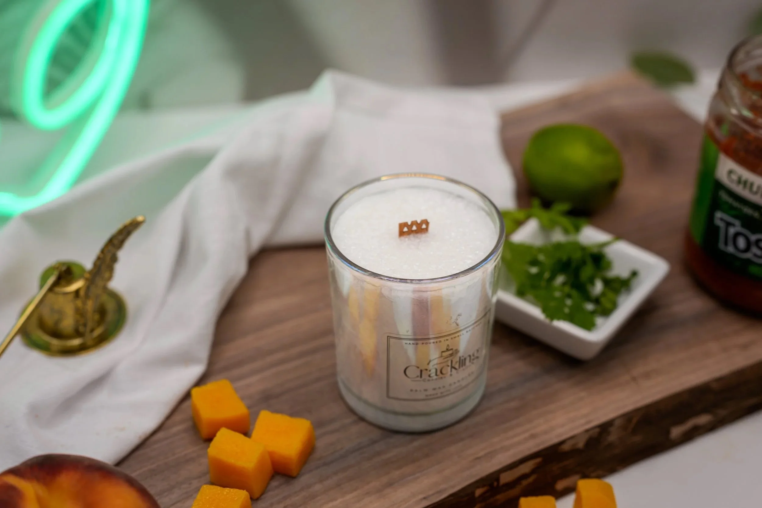 6 oz Fireball palm wax candle in a glass jar with a wooden wick, photographed on a wood surface