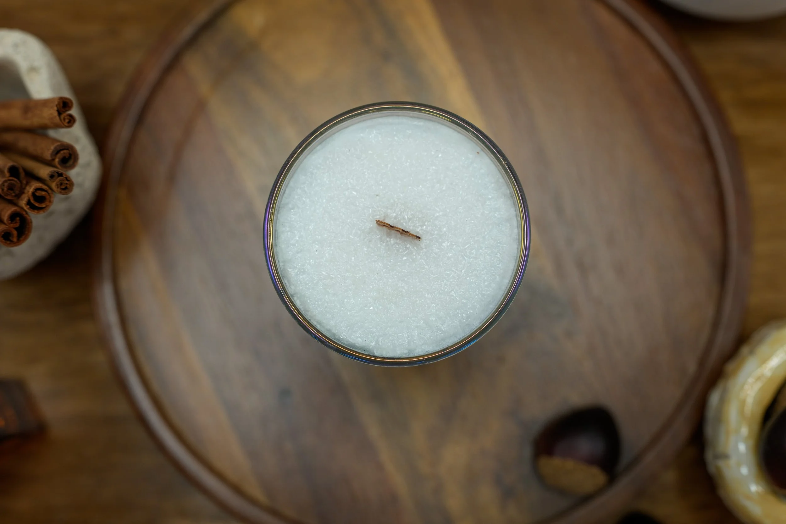 Overhead view of the 6 oz Tobacco & Oud candle showing its palm wax and wooden wick